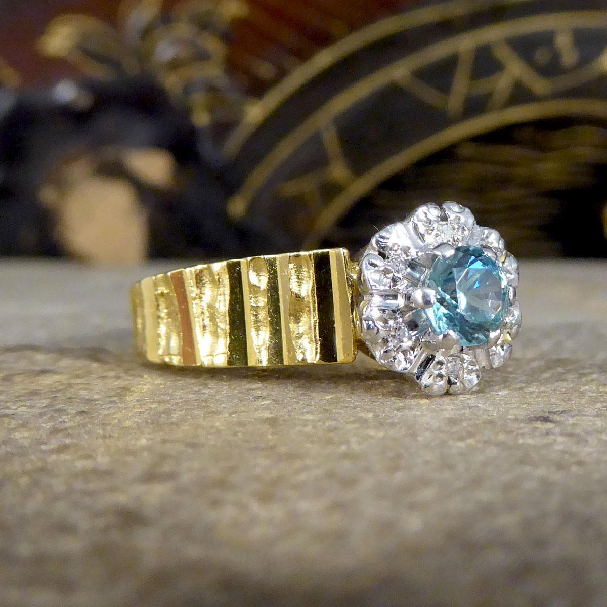 Such a gorgeous classic 1970's designed ring with a bark effect detail around the 18ct Yellow Gold band. The centre of the ring is a Zircon and Diamond cluster set in 18ct White Gold. The whole ring itself has been made with great detail and is a