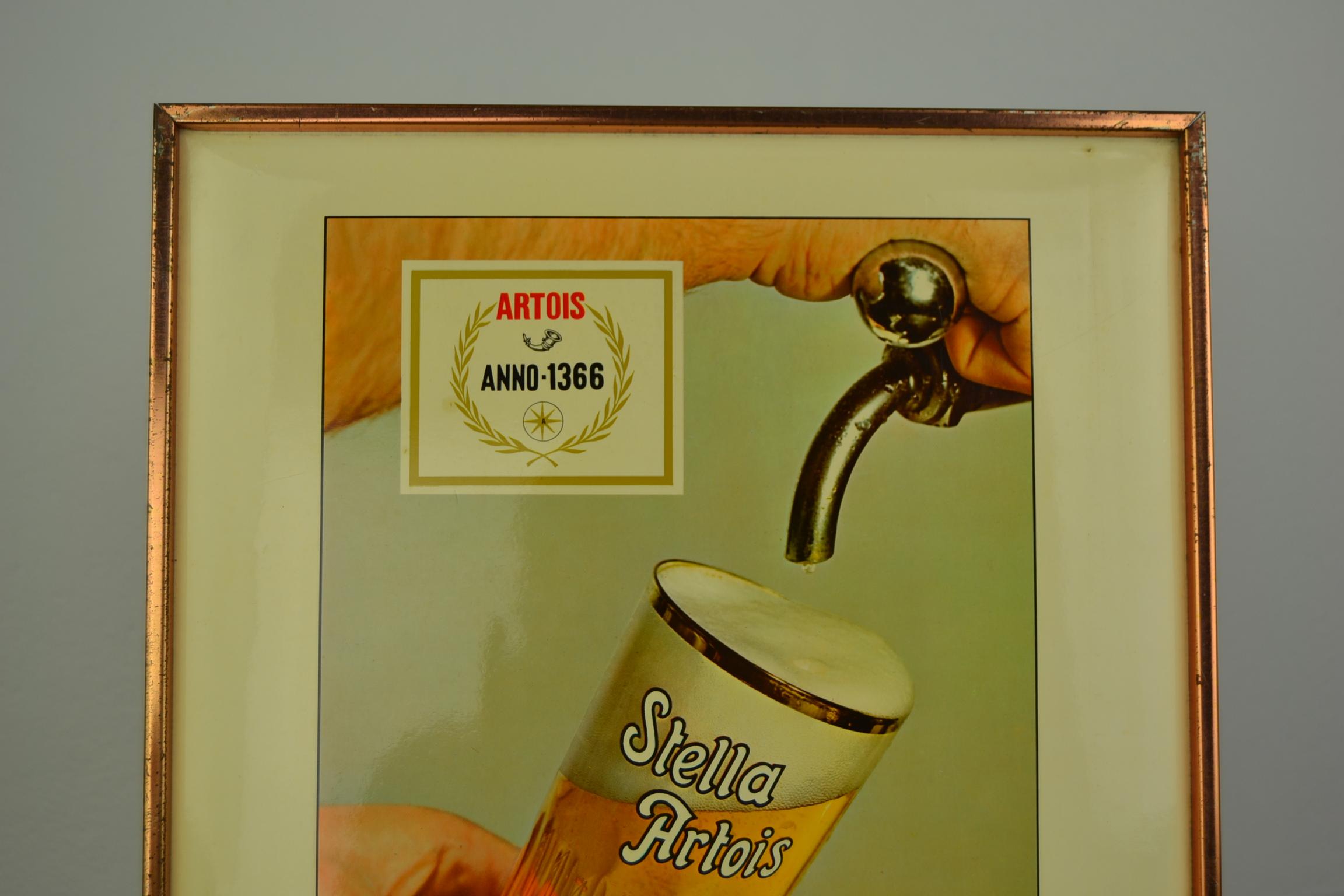 1970s Belgian beer sign for Stella Artois.
This sdvertising sign dates from 1971 and has the dated tax stamp on the back. 
It's a Glacoid sign mounted on cardboard in a tin frame. 
Made by Rob Otten plastics brussels. 

   