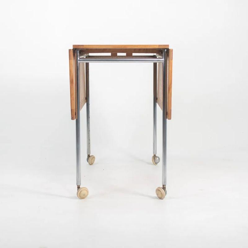 This is a Berit trolley or cart designed by Bruno Mathsson and produced by Firma Karl Mathsson in Sweden. The cart dates to 1971 and is properly marked underneath with the year of production. It is constructed from ash for the top and has a chromed