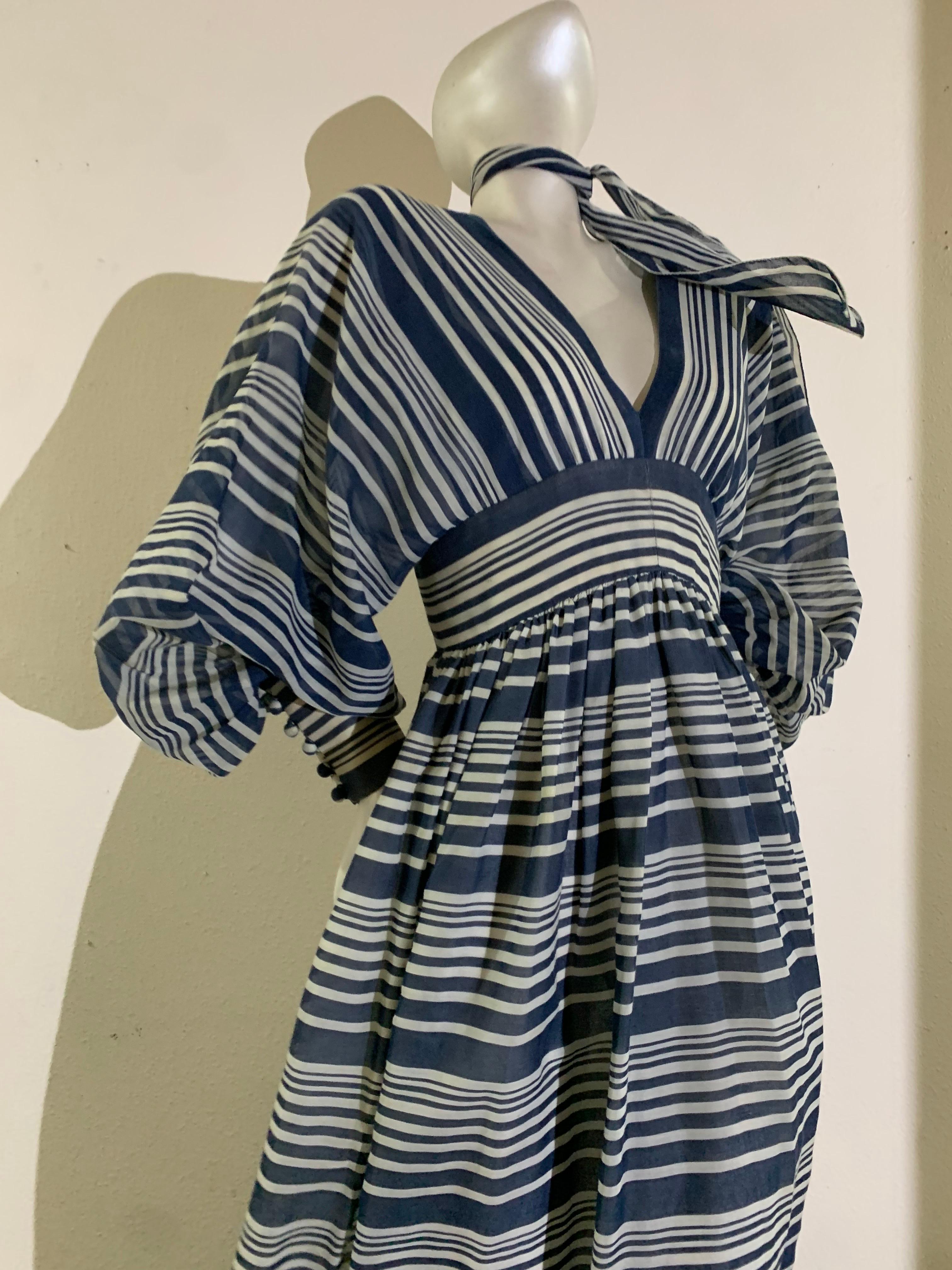 1971 Geoffrey Beene Navy & White Cotton Voile Peasant Gown w Bishop Sleeves:  Full voluminous skirt is gathered into a wide fitted waistband. Bias-cut full sleeves gathered into a very wide cuff that is closed with covered buttons. Lined in a sheer