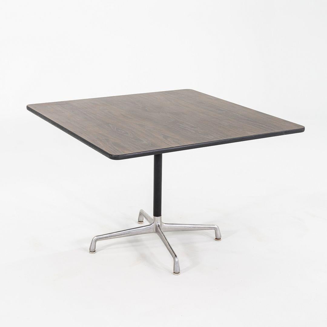 This is an Eames Universal Dining Table, Model ET206, originally designed by Ray and Charles Eames in 1961. This particular example was produced by Herman Miller in the USA C. 1971. The table's design is comprised of a sand casted aluminum base with