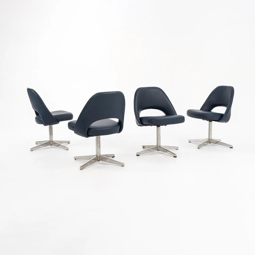 This is a set of four Saarinen armless executive side chairs on pedestal bases, originally designed by Eero Saarinen for Knoll in 1950. These particular examples are circa 1971 production examples with newly done upholstery. The listed price