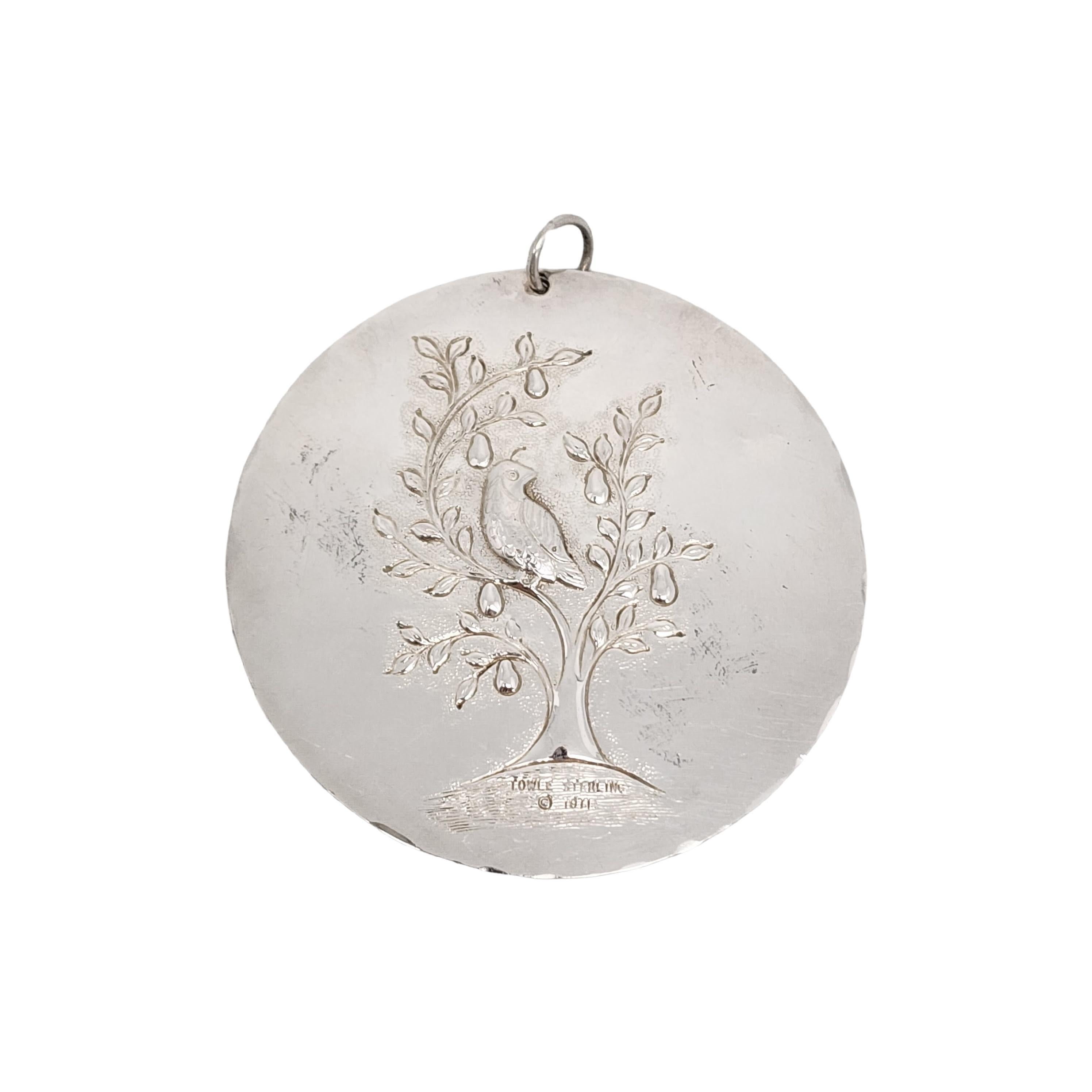 Towle sterling silver 12 Days of Christmas, Partridge in a Pear Tree ornament from 1971.

Part of the yearly tradition of Towle's 12 Days of Christmas ornament set, this ornament depicts a partridge in a pear tree on one side, and a flying dove with