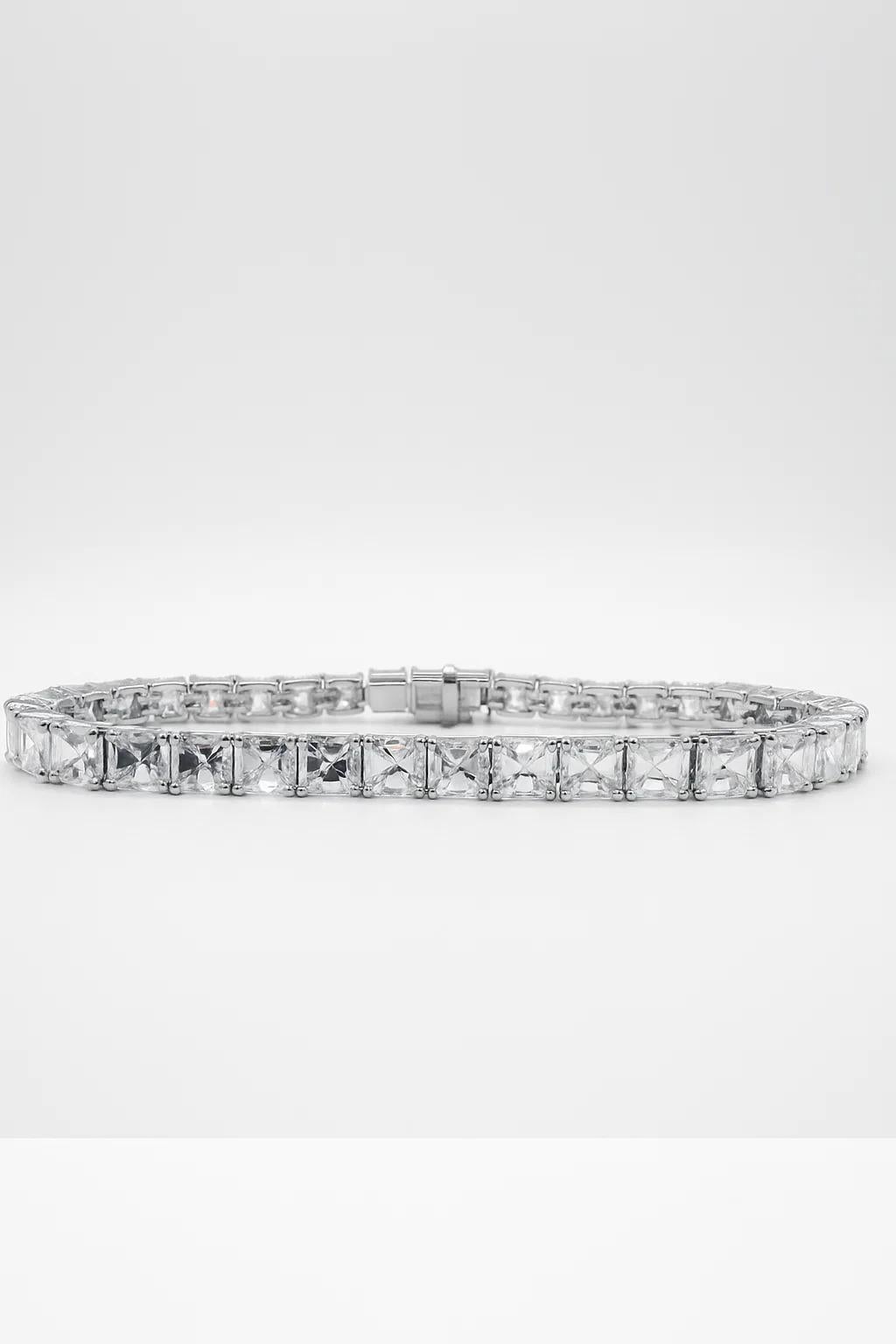 This exceptional Asscher cut diamond tennis bracelet is a modern masterpiece of precision and elegance. Crafted in platinum, the design features 19.72 carats of beautifully matched Asscher cut diamonds, each boasting a crisp step-cut faceting style