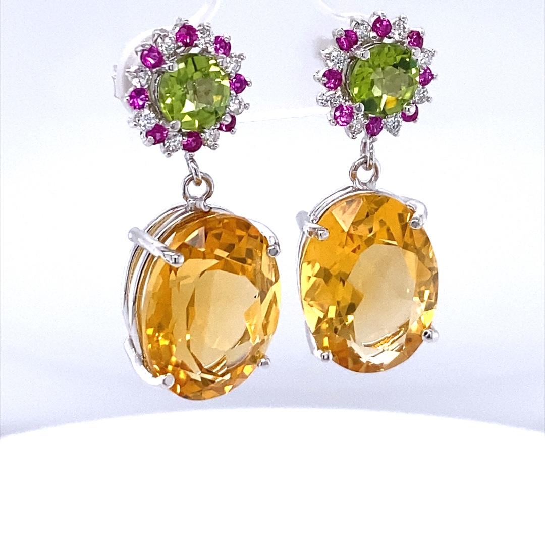 19.72 Carat Citrine Pink Sapphire Diamond Earrings 14 Karat Yellow Gold

These lovely earrings have 2 vibrant Oval Cut Citrine Quartz that weigh 17.38 carats.  There are also 2 Round Cut Peridots on the top of the earrings that weigh 1.69 carats and