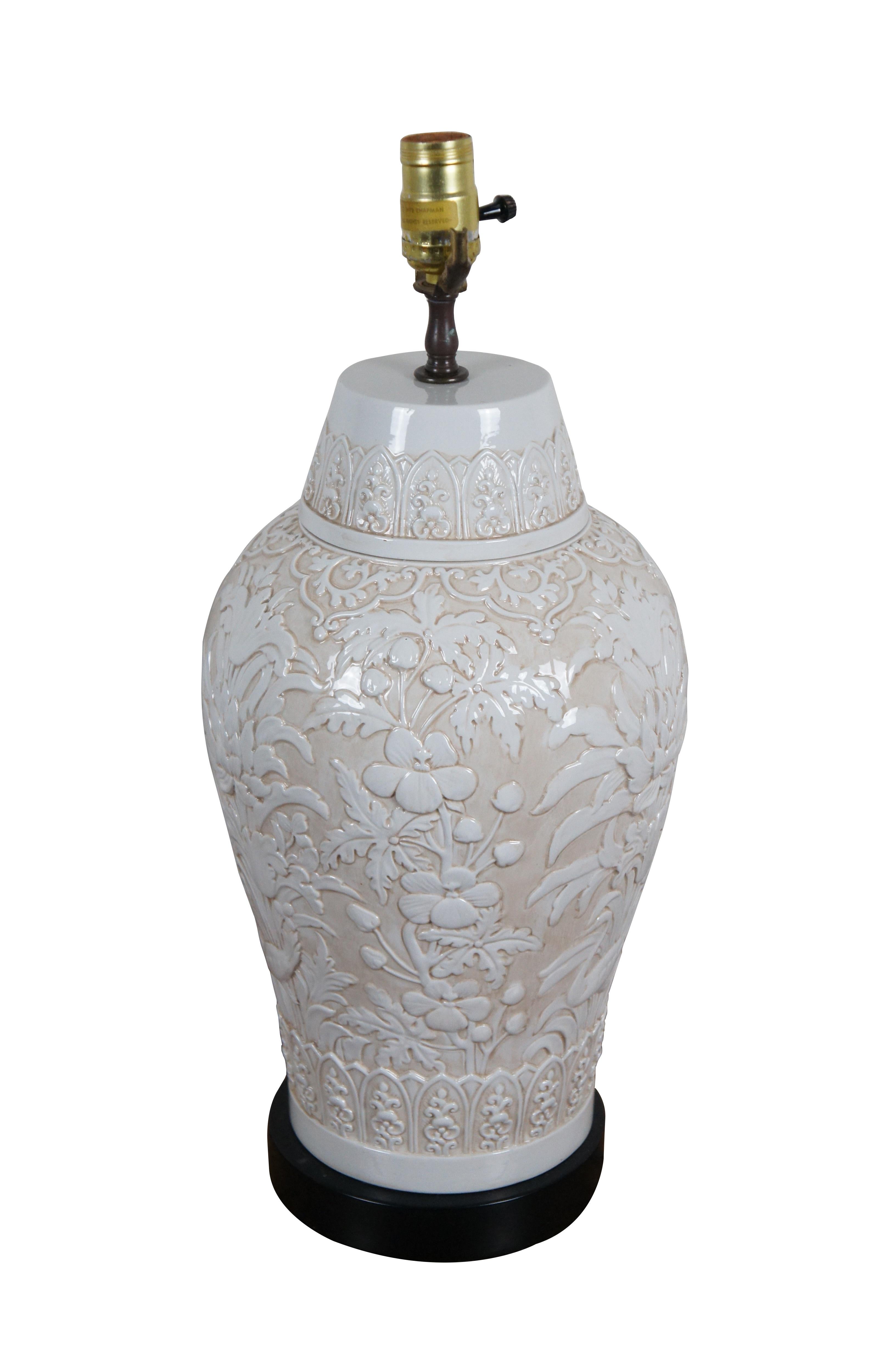 Vintage 1972 Chapman table lamp, crafted from porcelain featuring a chinoiserie design of flowers / chrysanthemum and birds in white relief on a beige ground, mounted on a simple black base. No harp or shade.

Dimensions:
9.75