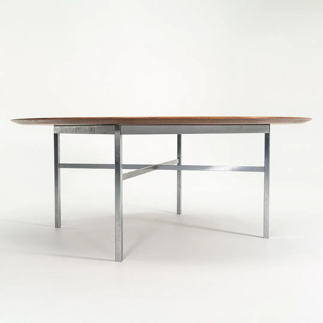 This is an original custom Florence Knoll Dining or Conference Table, featuring a walnut top and a chromed-steel base. The table was manufactured in the USA by Knoll in 1972. 

The piece measures 72 inches in diameter (round), and is 28.5 inches in