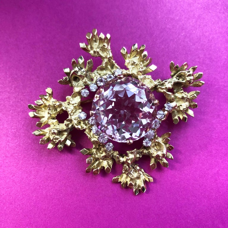 A faceted Morganite, diamond and 18 karat gold brooch, by John Donald, 1972.
The brooch is stamped with maker's mark JAD, and dated with London hallmarks. 

John Donald is a designer and goldsmith born in Surrey, England. Originally a student of