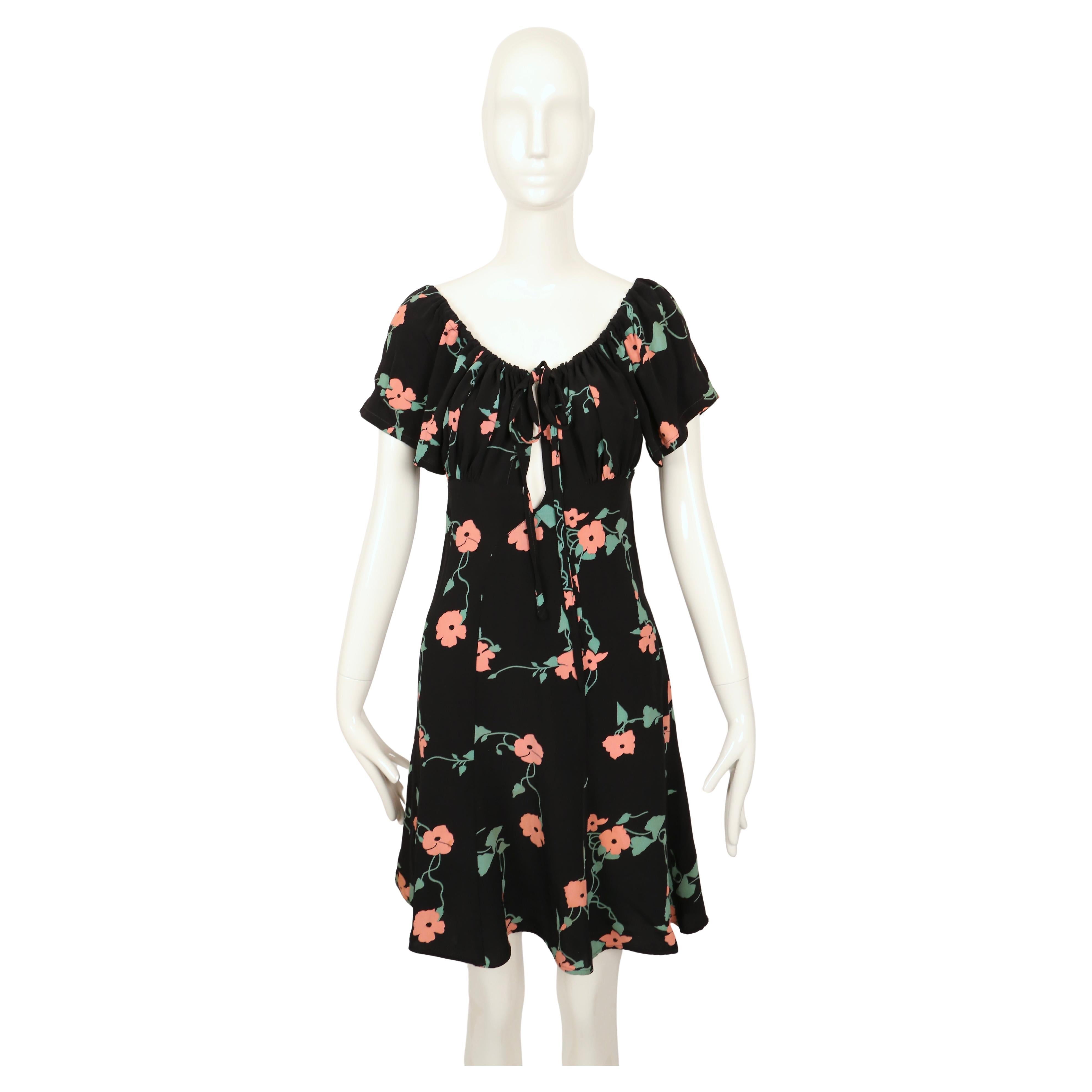 Very rare black dress by Ossie Clark with 'Busy Lizzie' print by Celia Birtwell dating to 1972. Dress best fits a US 2-4. Approximate measurements: waist 26