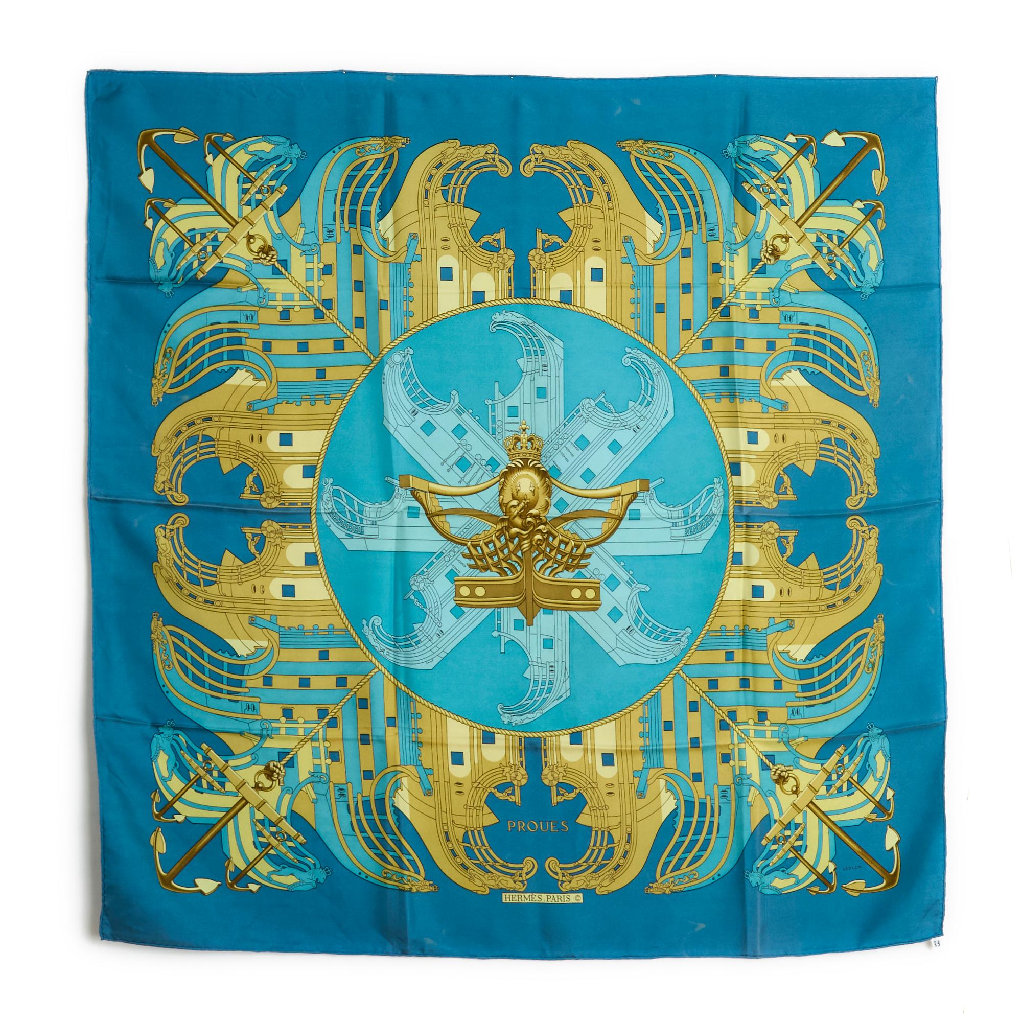 Hermès square 90 scarf in silk twill, Proues pattern by Philippe Ledoux, published in 1973, patterns in turquoise blue and gold tones, ultramarine blue edges. Width 90 cm x length 90 cm approximately. The square is vintage and it shows a few traces