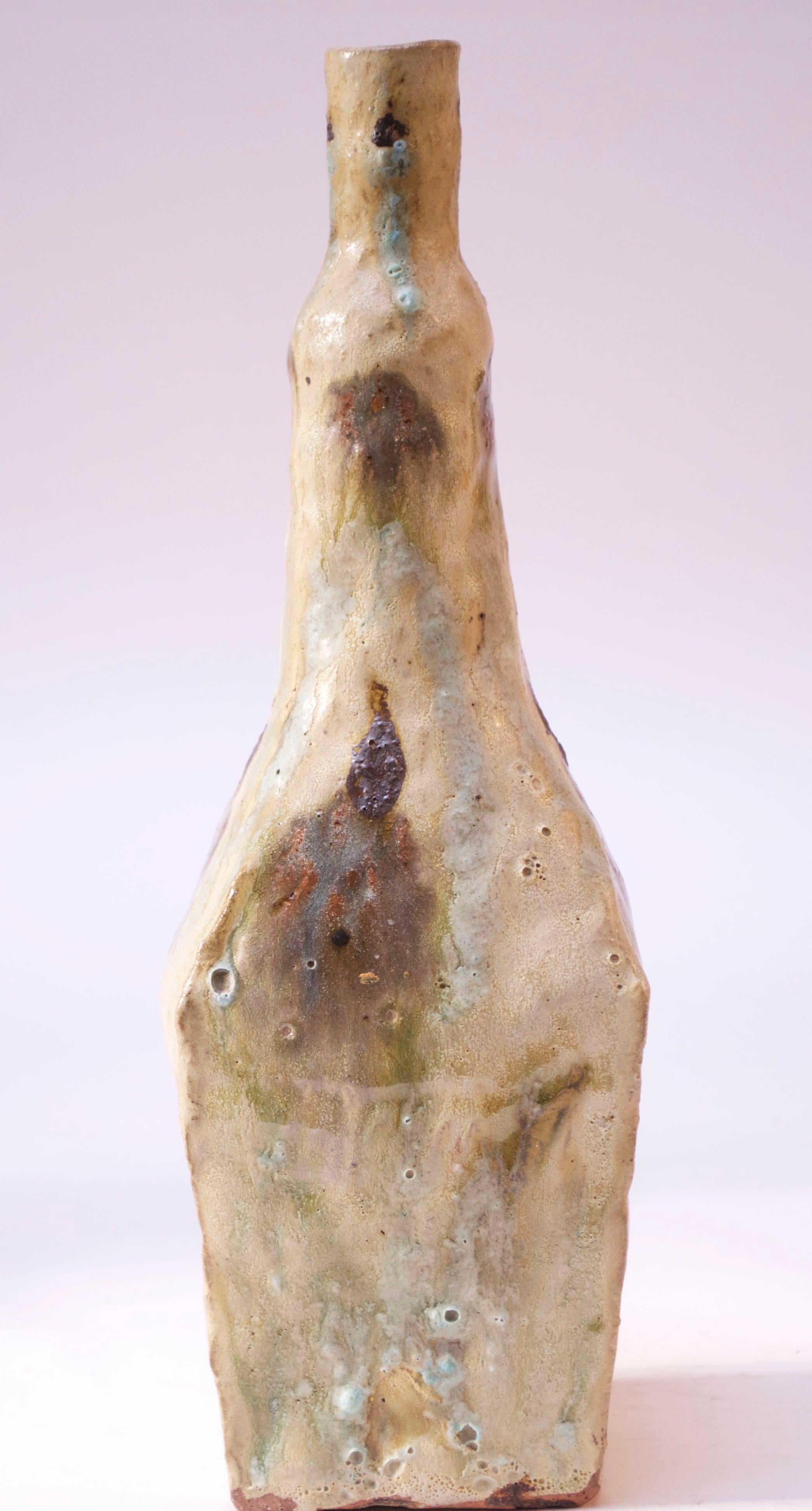 This ceramic vase by the notable Irish ceramicist, John Ffrench, is a more crude / primitive example of Ffrench’s work composed of a lava-drip glaze in turquoise and brown against a taupe background. Ffrench was the artist credited for introducing