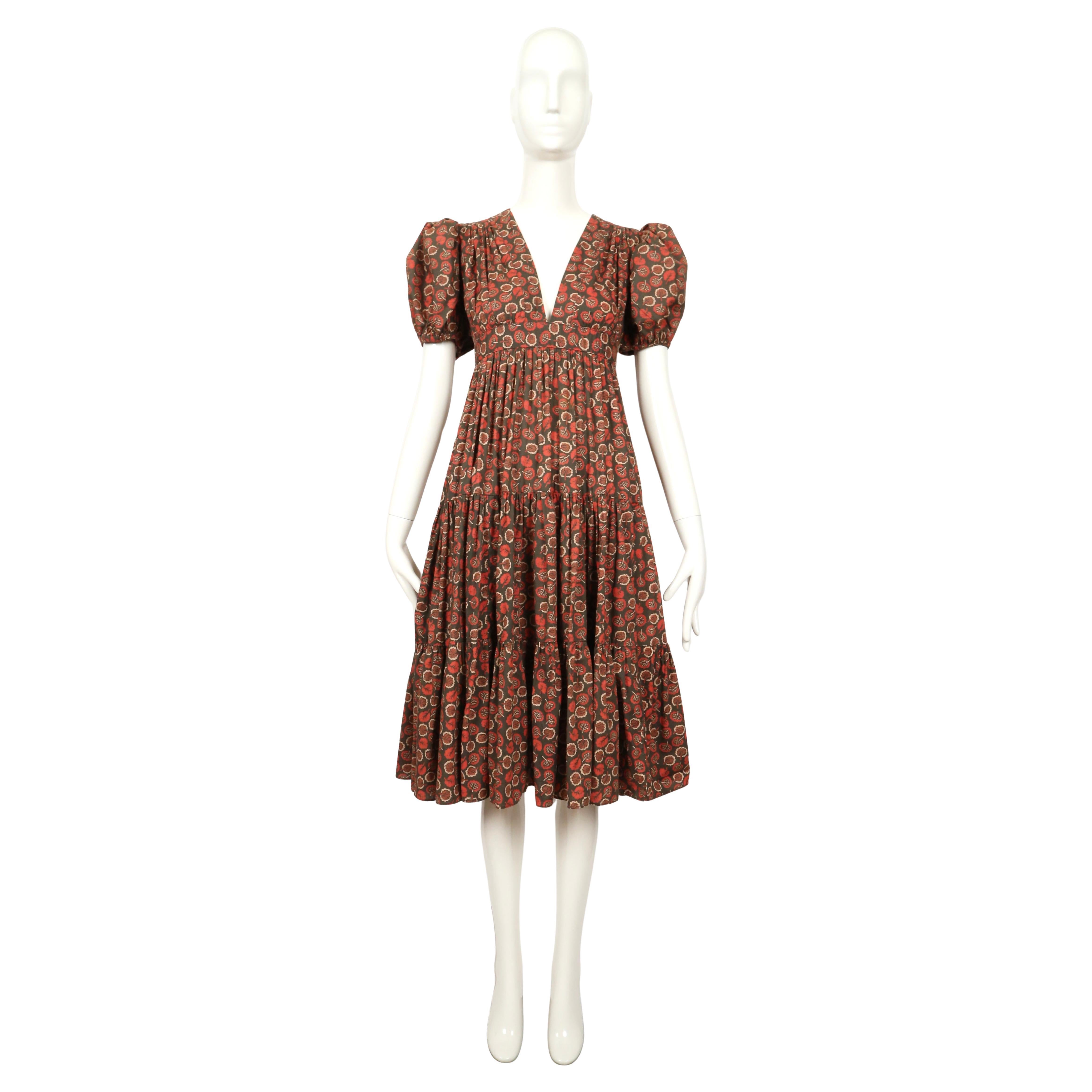 Very rare, tiered dress made of Celia Birtwell printed fabric with leaf motif designed by Ossie Clark dating to 1973. Dress features puff sleeves and an empire waistline with a very voluminous skirt.

Dress is labeled a UK size 12 however it fits