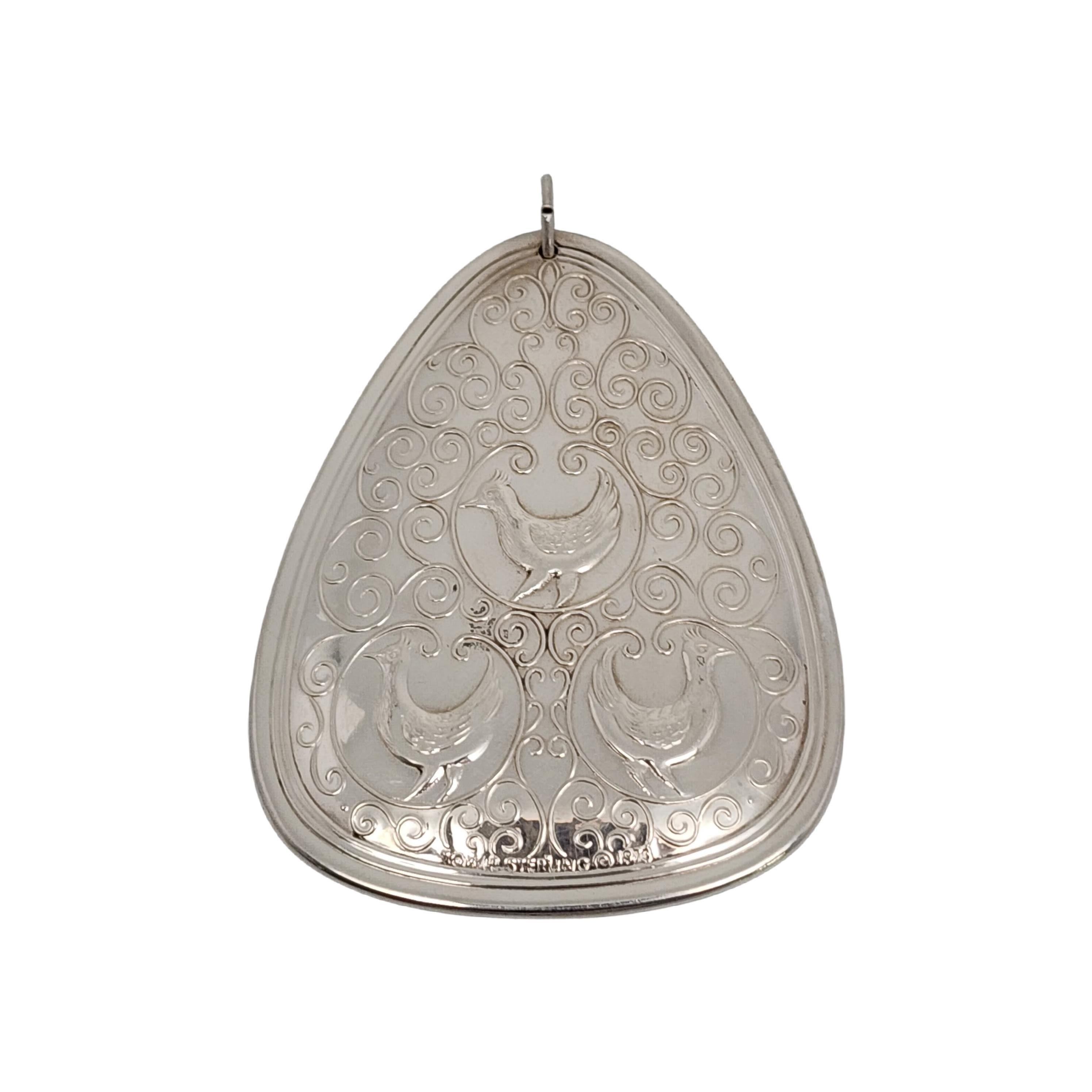 Towle sterling silver 12 Days of Christmas, 3 French Hens ornament from 1973.

Part of the yearly tradition of Towle's 12 Days of Christmas ornament set, this ornament depicts 3 hens amid a swirled background on one side, and a flower on the other