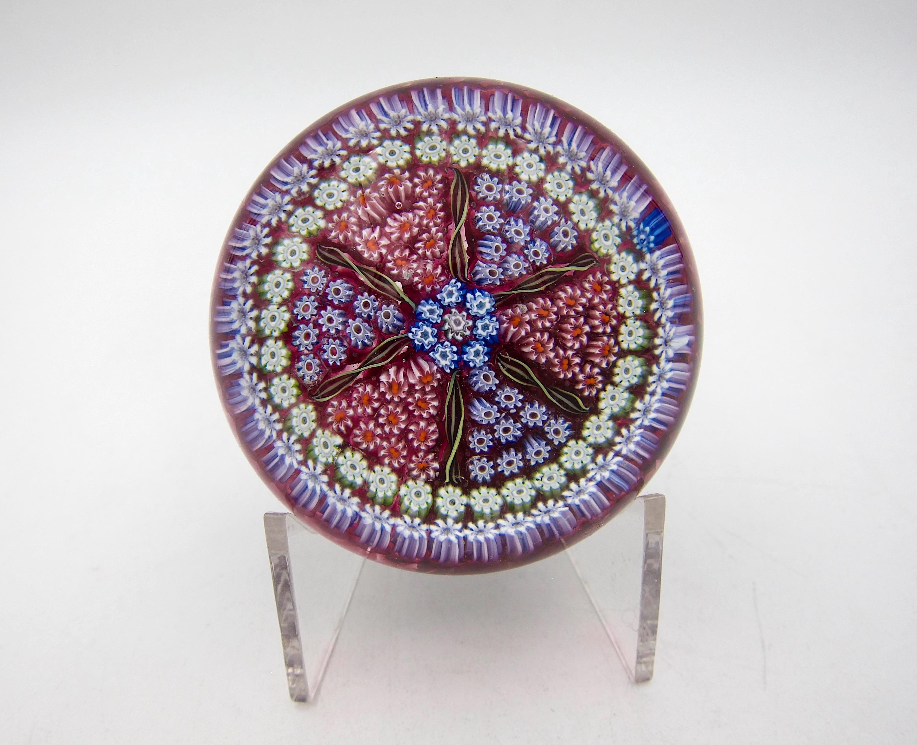A vintage miliiefiori art glass paperweight, handcrafted by Perthshire Paperweights, Ltd. of Crieff, Scotland. The PP25 weight was produced as a limited edition in 1974-1975. The domed weight was designed in a 1-2-3-4 pattern of colorful millefiori