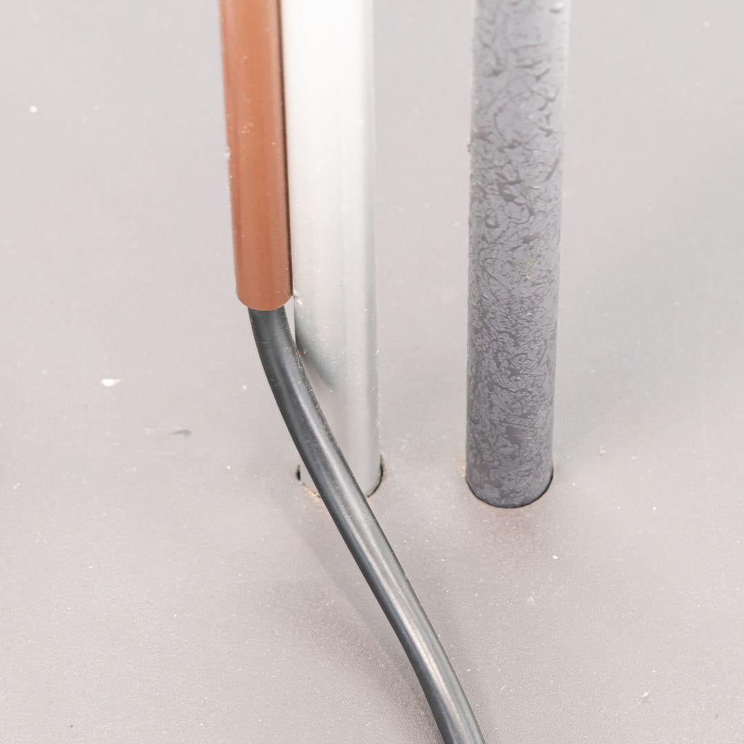 This is an ‚ÄòAggregato Terra‚Äô Floor Lamp, designed by Enzo Mari and Giancarlo Fassina for Artemide in 1974. The lamp was produced in Italy and features a metal base & stem, and has a blue-green plexiglass diffuser shade. It has a US compatible