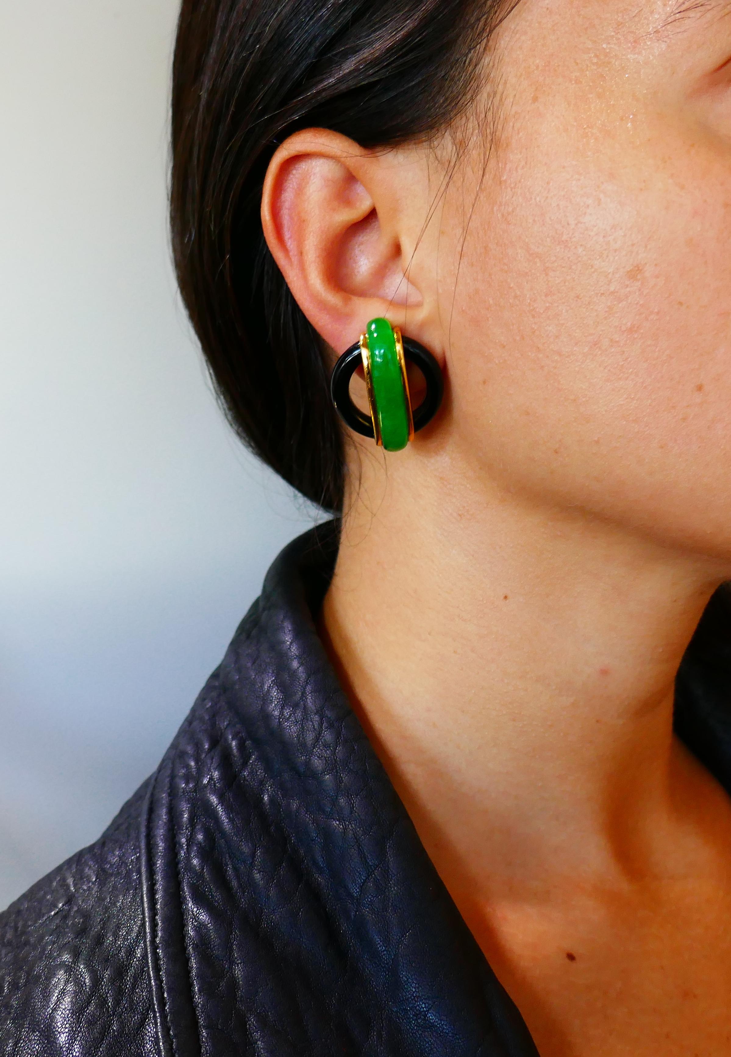 Colorful elegant ear-clips created by Aldo Cipullo in 1974. Made of Black onyx, jade and 18k (stamped) yellow gold. Sharp geometrical design and dramatic color combination are the highlights of these stylish earrings. 
They measure 1-1/4