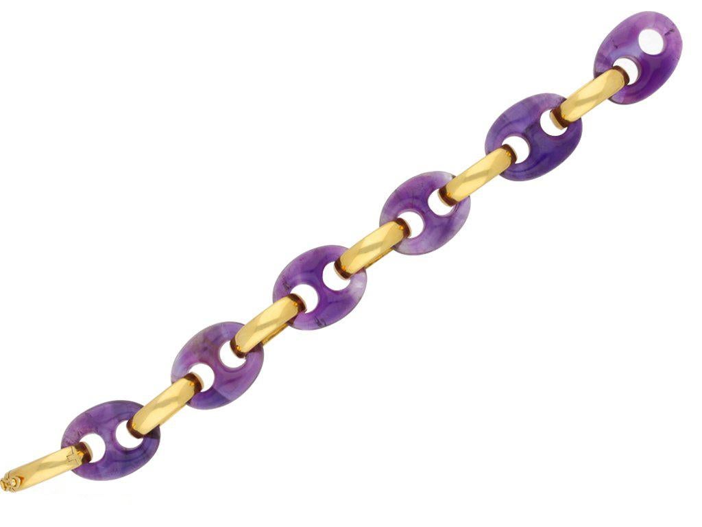 Amethyst bracelet by Garrard & Co. Set with six oval pierced amethyst links with a combined approximate weight of 120 carats, to an articulated bracelet with curved yellow gold bar shaped spacers, smoothly conforming to the wrist, with a hidden