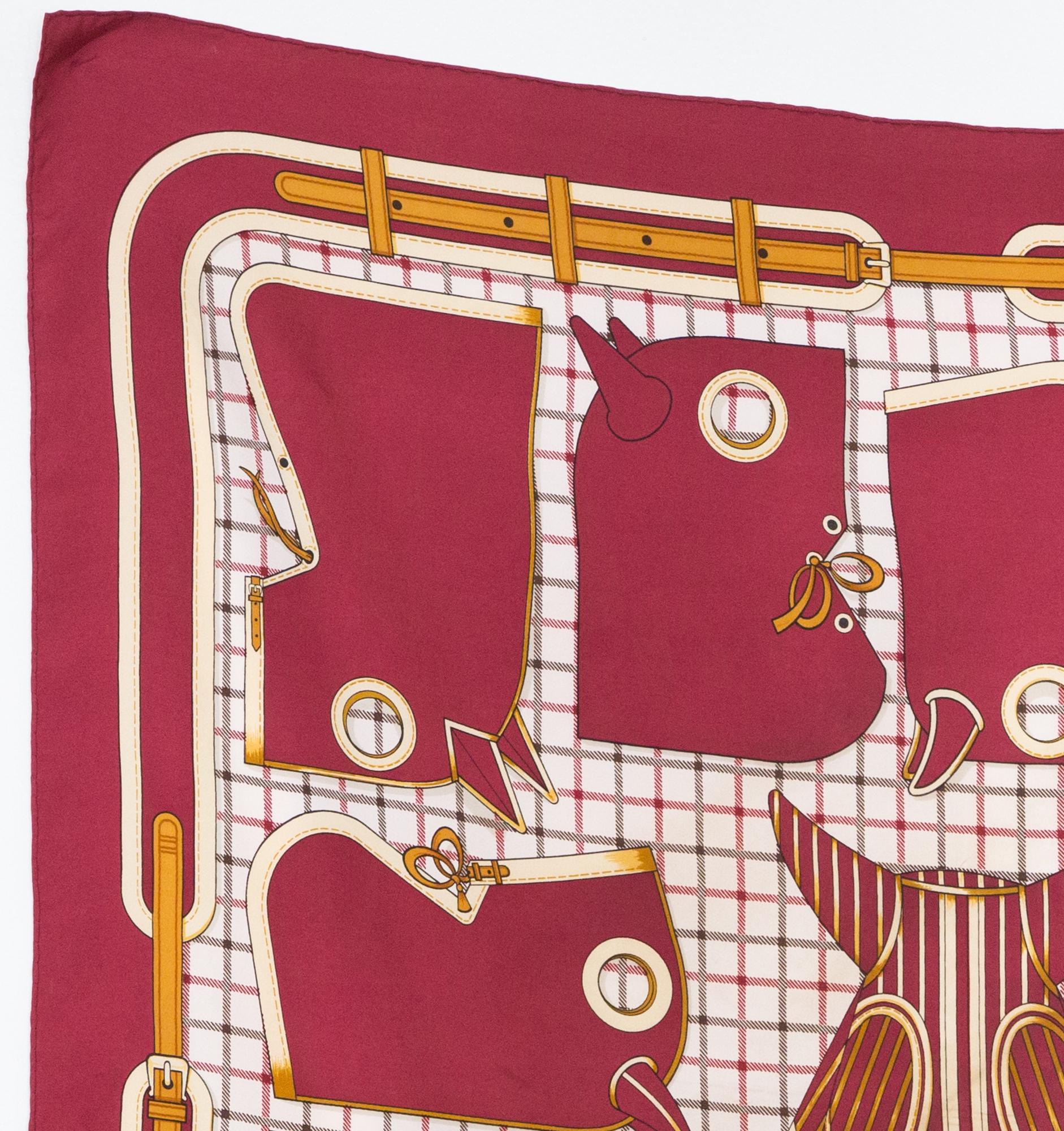 1974 Hermes silk scarf Camails designed by Francoise de la Perriere featuring a red border and a Hermès signature. 
Camails was created in 1948.
In good vintage condition. Made in France.
35,4in. (90cm)  X 35,4in. (90cm)
We guarantee you will