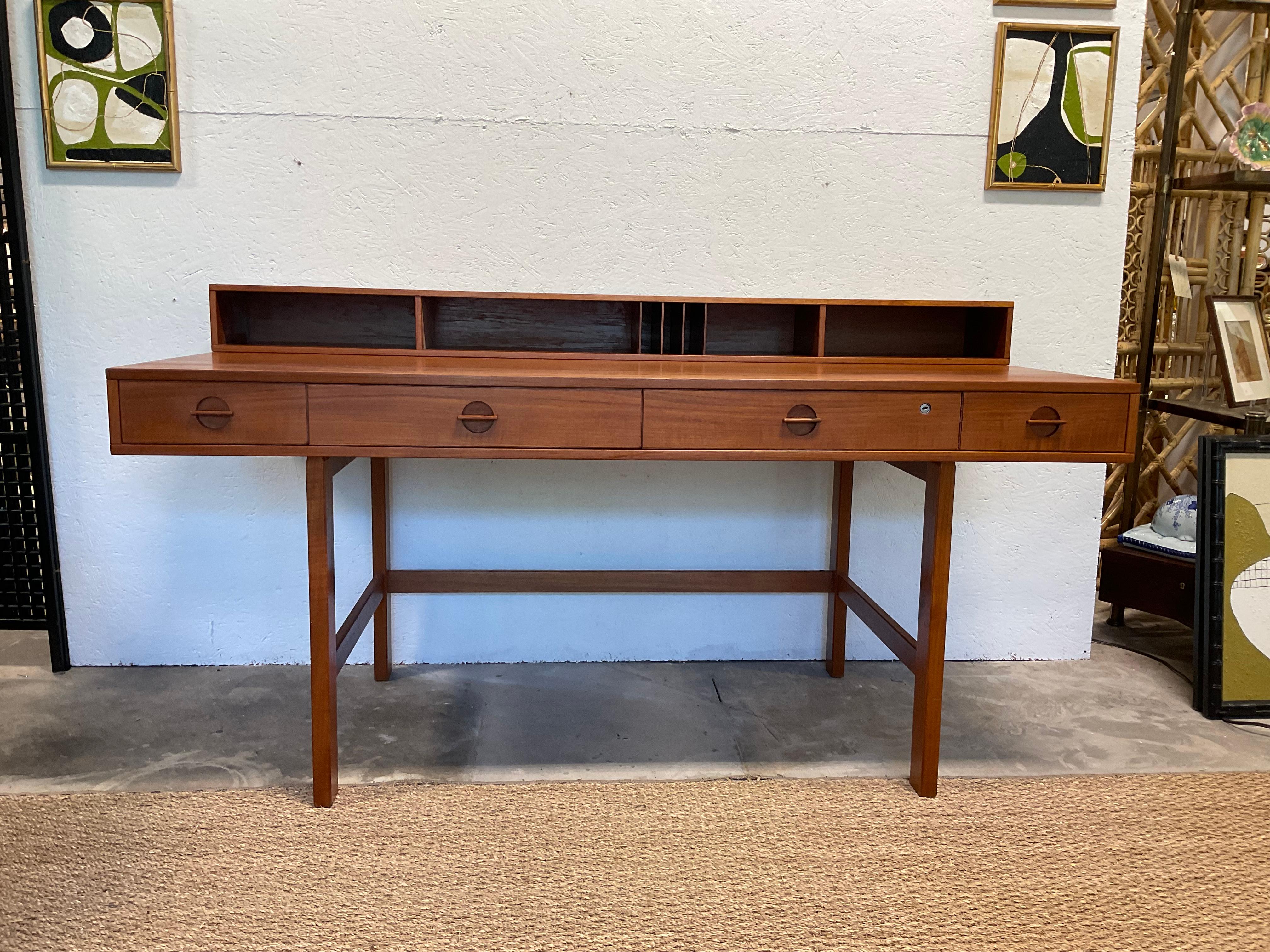 This desk is instantly recognizable, and is considered a classic. Peter Nielsen Lovig for Dansk flip top / partners desk, in teak. The desk is dated 1974 and is in very good, original condition. It has been cleaned, and oiled. The desk can be used