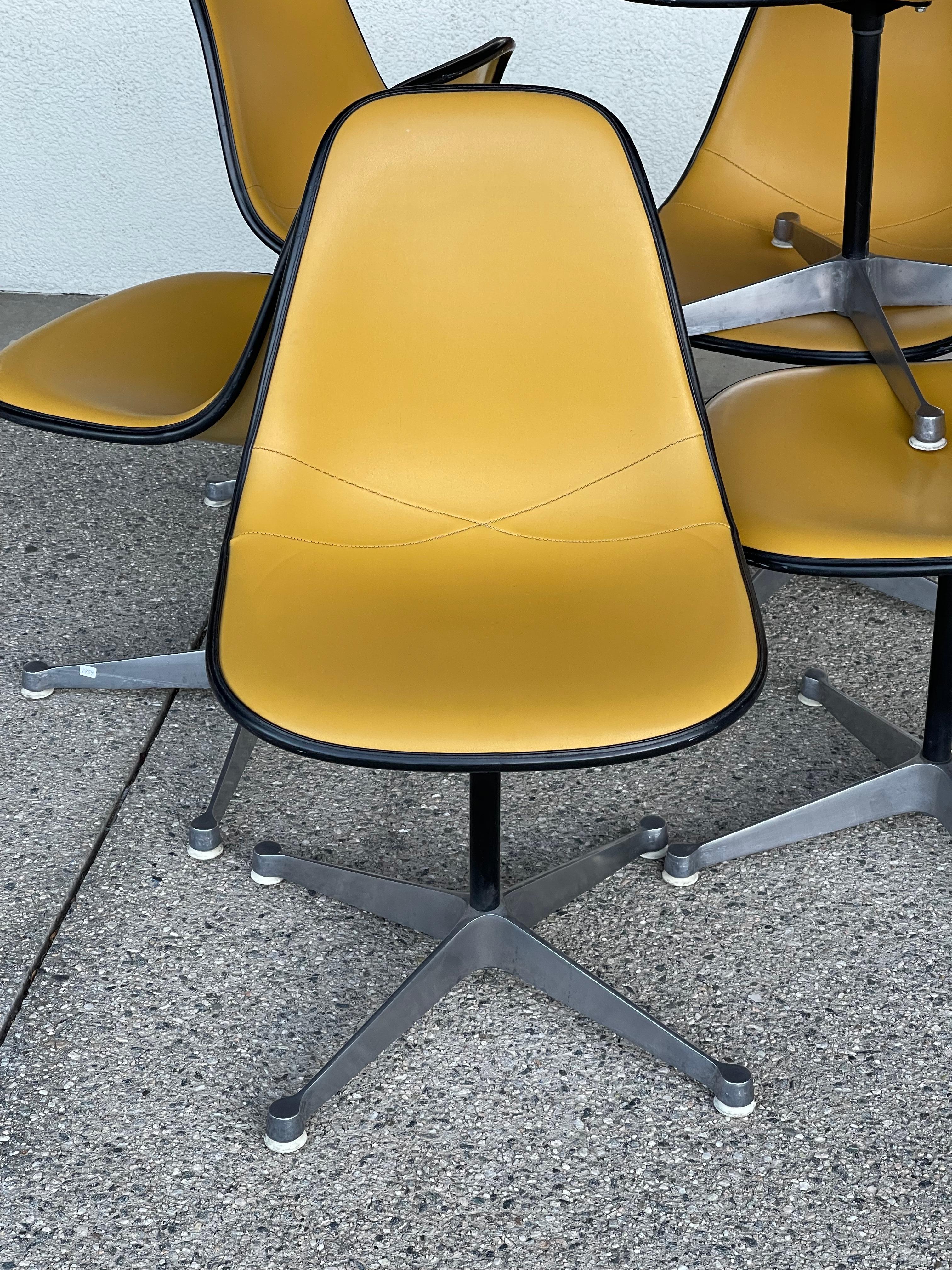 Great set of 6 stamped 1975 Eames for Herman Miller swivel chairs with fiberglass shells and vinyl or Naugahyde upholstery. Wonderful condition for their age. Some of the chairs even have the original inspected by tag. Dated April 15, 1975. We