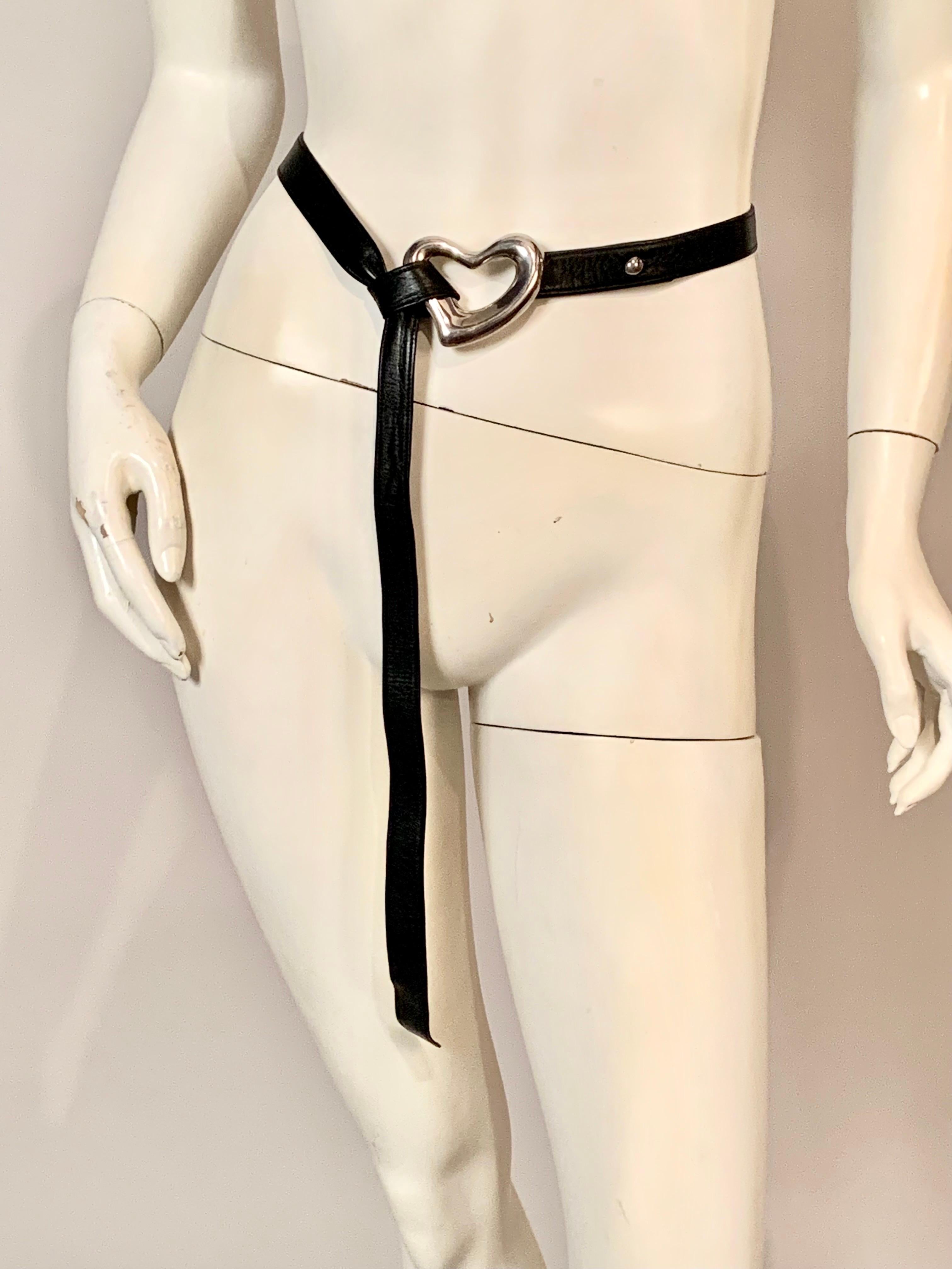 This classic and early Elsa Peretti belt is dated 1975, and it is from the very early years of her collaboration with Halston and Tiffany & Co.  There is a sterling button to secure the buckle to the belt marked Peretti and Tiffany, and two leather