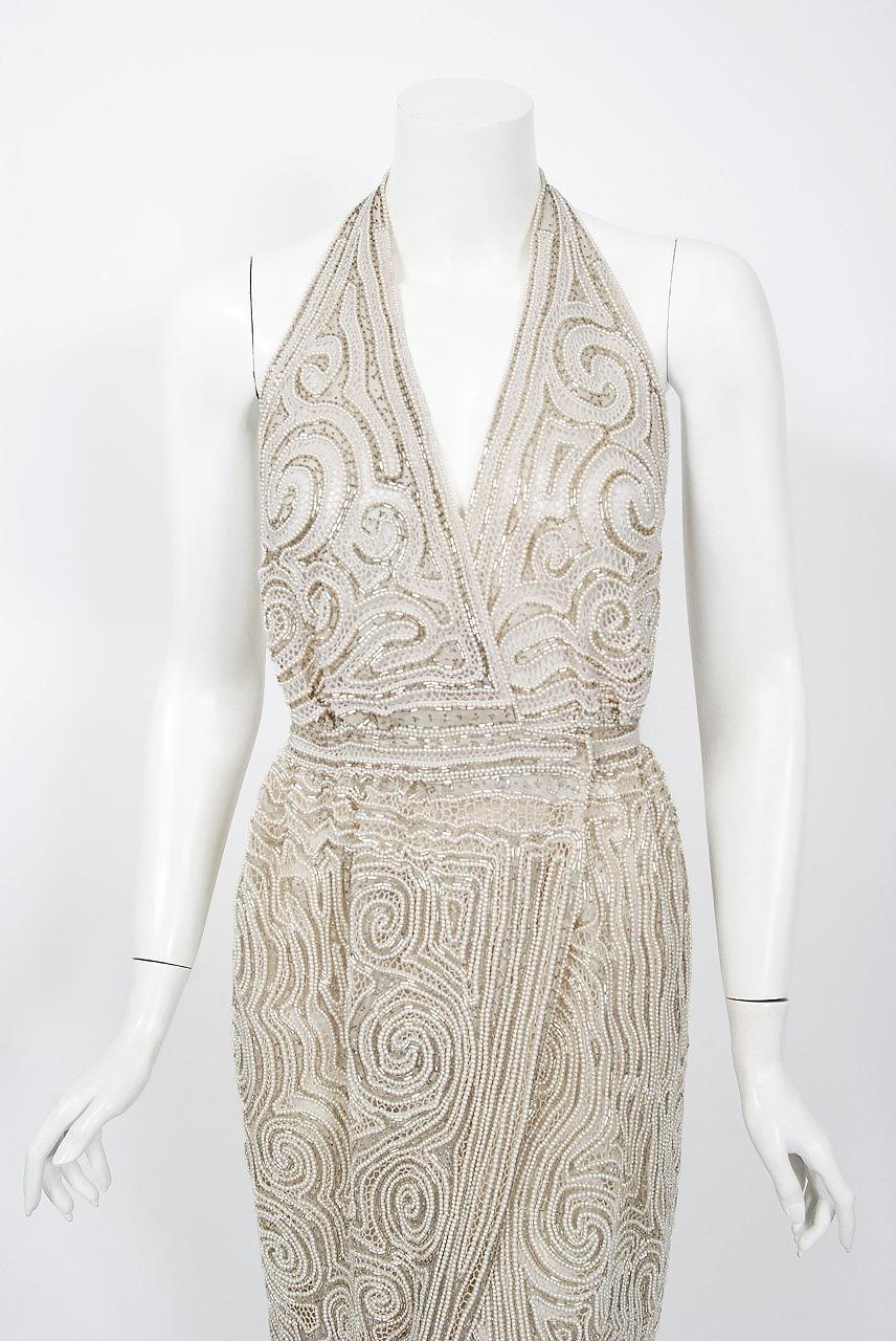 Gorgeous Halston Couture beaded wrap gown dating back to the mid 1970's. Halston revolutionized the way women dress and is one of the few designers, alongside Claire McCardell and Norman Norell, to define what is American fashion. Throughout most of