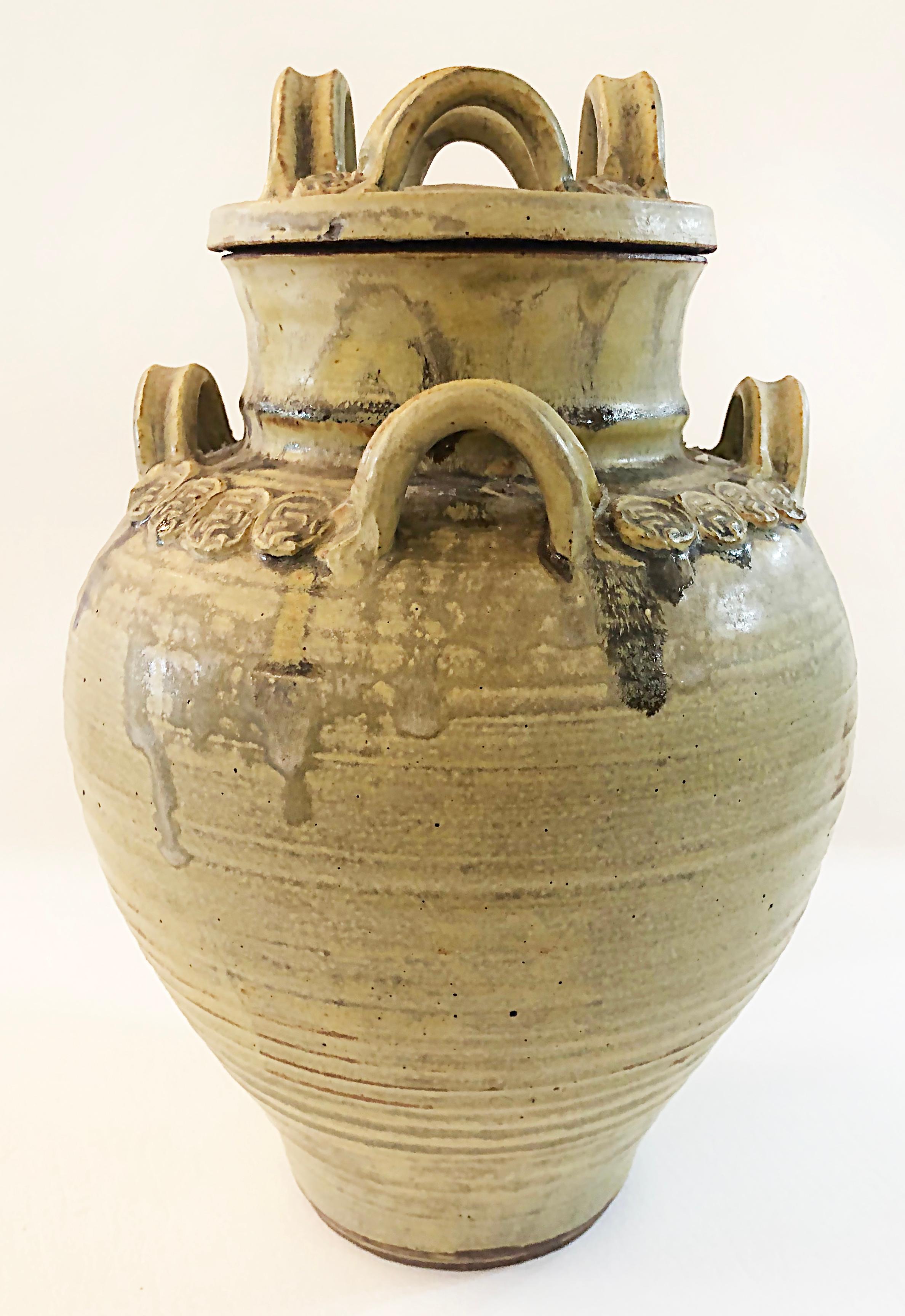 1975 Thrown and Built Studio Pottery Lidded Urn, Signed

Offered for sale is a hand-thrown and hand-built glazed studio pottery urn featuring four handles on the shoulders and the lid. The urn is signed and dated '75 on the underside. 

DIMENSIONS: