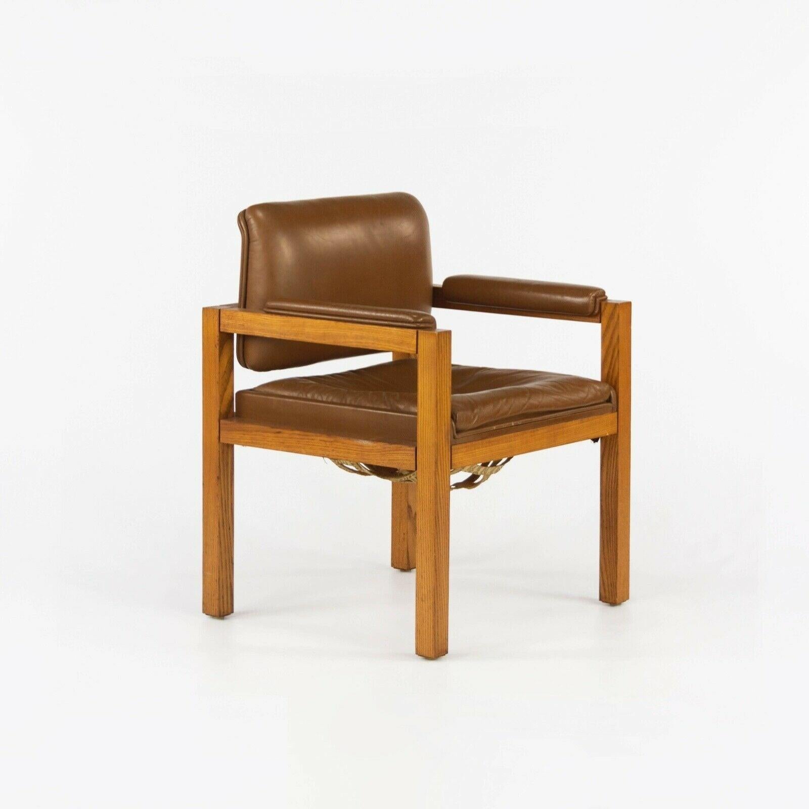 Listed for sale is a circa 1975 production oak and leather armchair designed by renowned architect and furniture designer Warren Platner. This piece was part of a series that Platner designed for CI Designs in the 1970s. CI Designs was based in