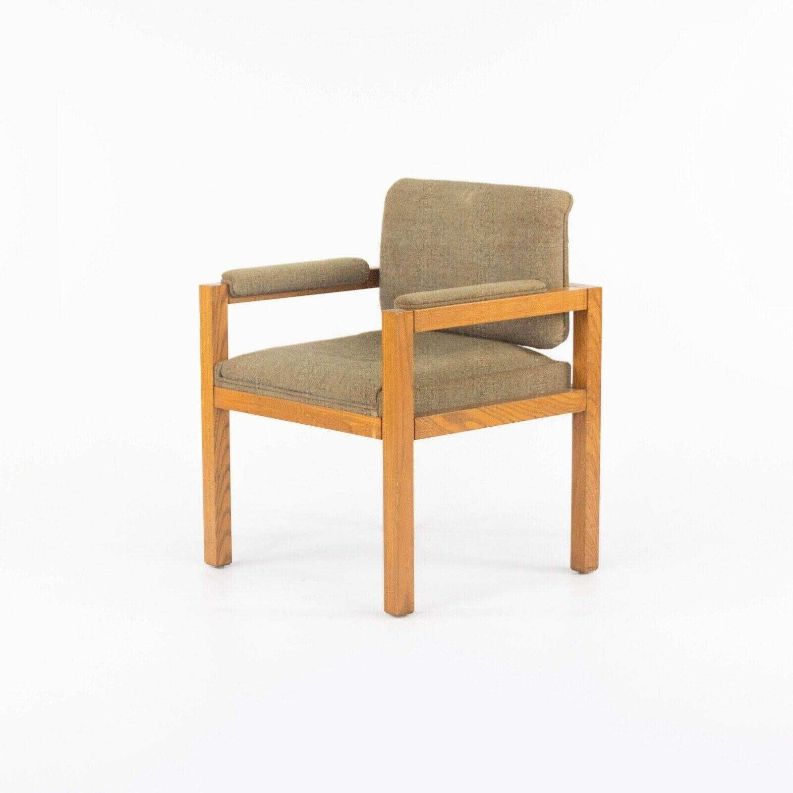 Listed for sale is a circa 1975 production oak and dark tan fabric armchair designed by renowned architect and furniture designer Warren Platner. This piece was part of a series that Platner designed for CI Designs in the 1970s. CI Designs was based