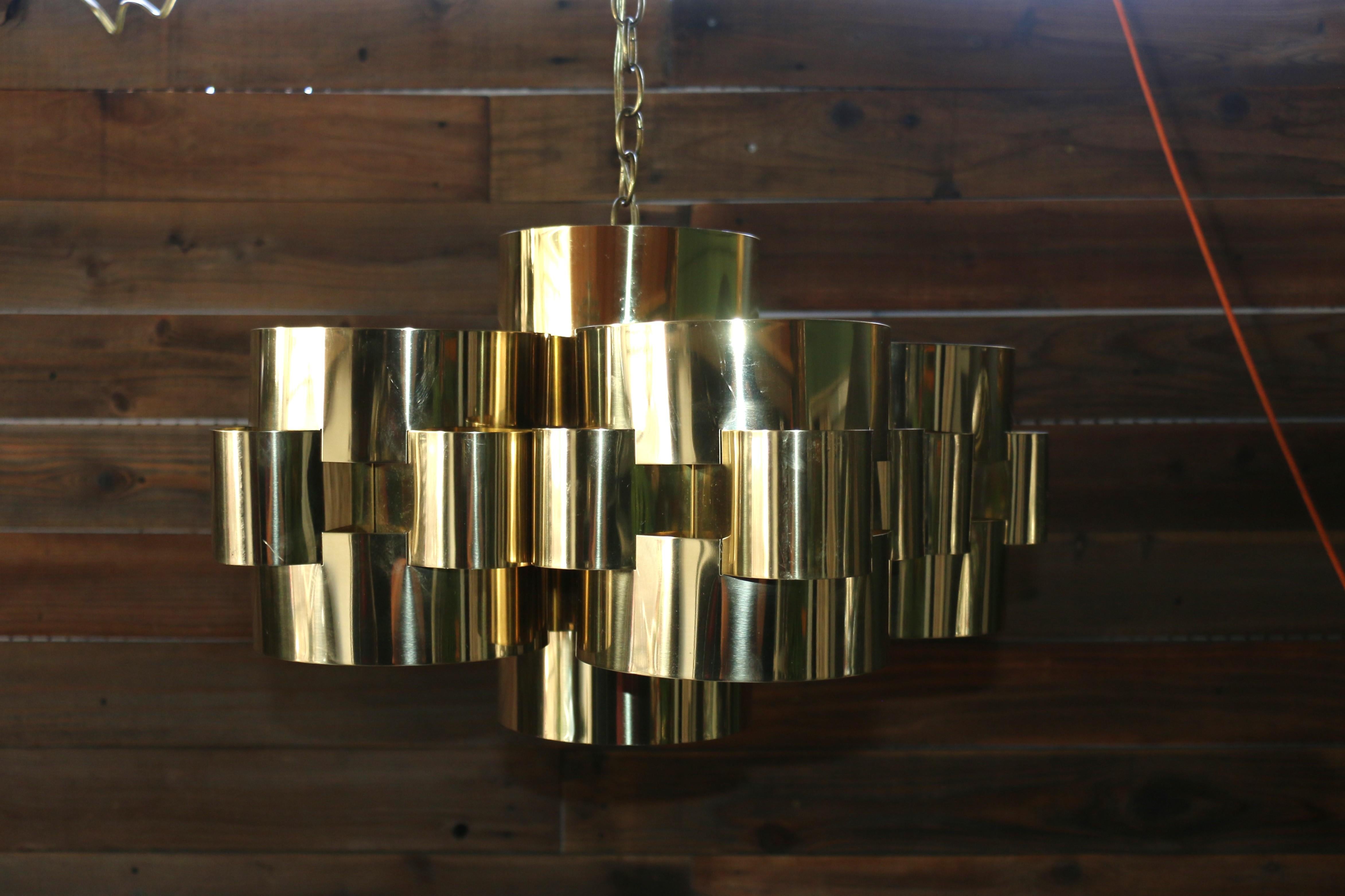 Iconic chandelier designed by Curtis Jere in the United States, ( this chandelier is signed by the makers ). Amazing chandelier made of polished brass interlocking cylinder design, featuring a cloud. An absolutely magnificent design. It will