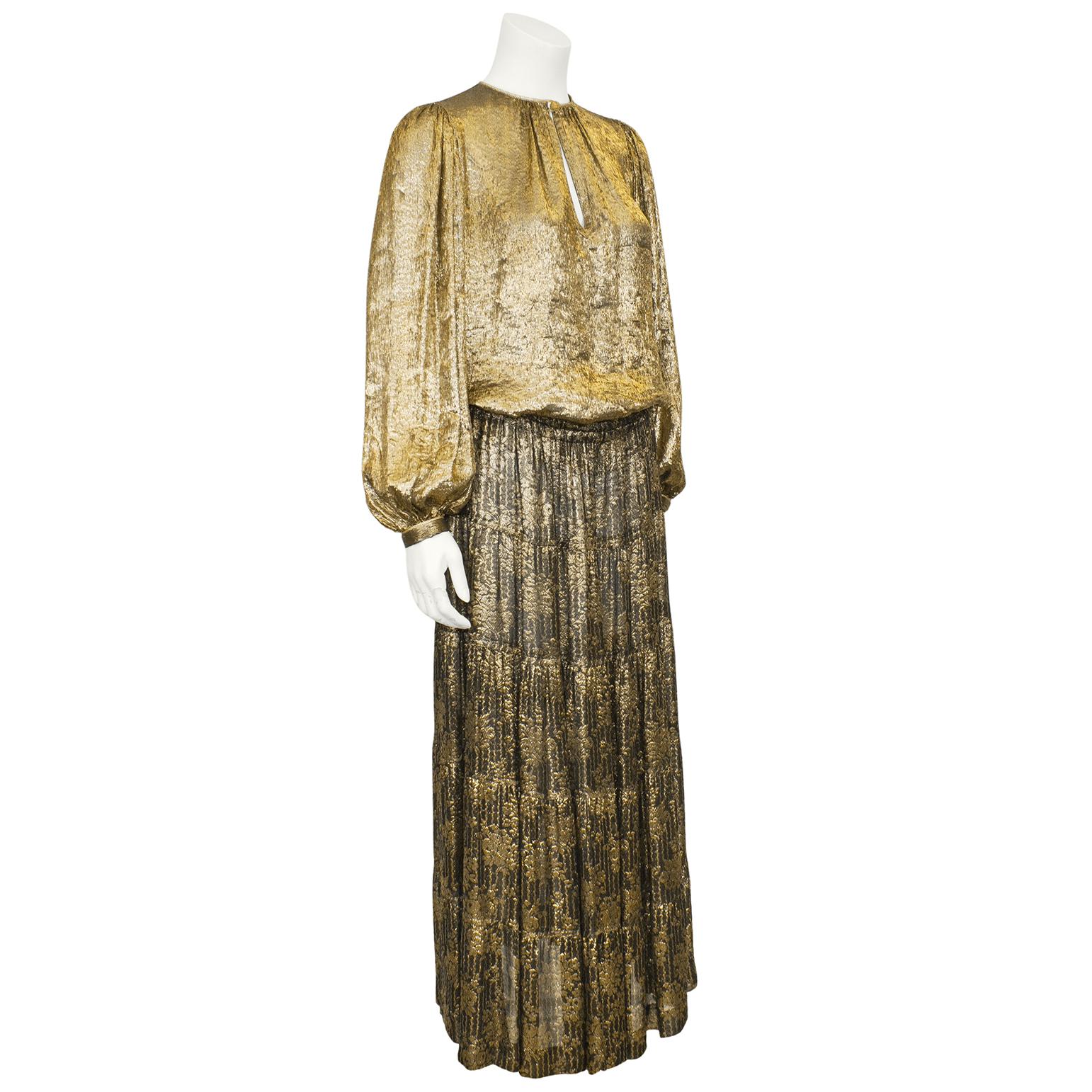 Beautiful metallic gold blouse and skirt ensemble from the famed 1976/1977 Yves Saint Laurent Russian collection. Versions of the ensemble have been published and documented numerous times. Both pieces in the ensemble are peasant style, as were most