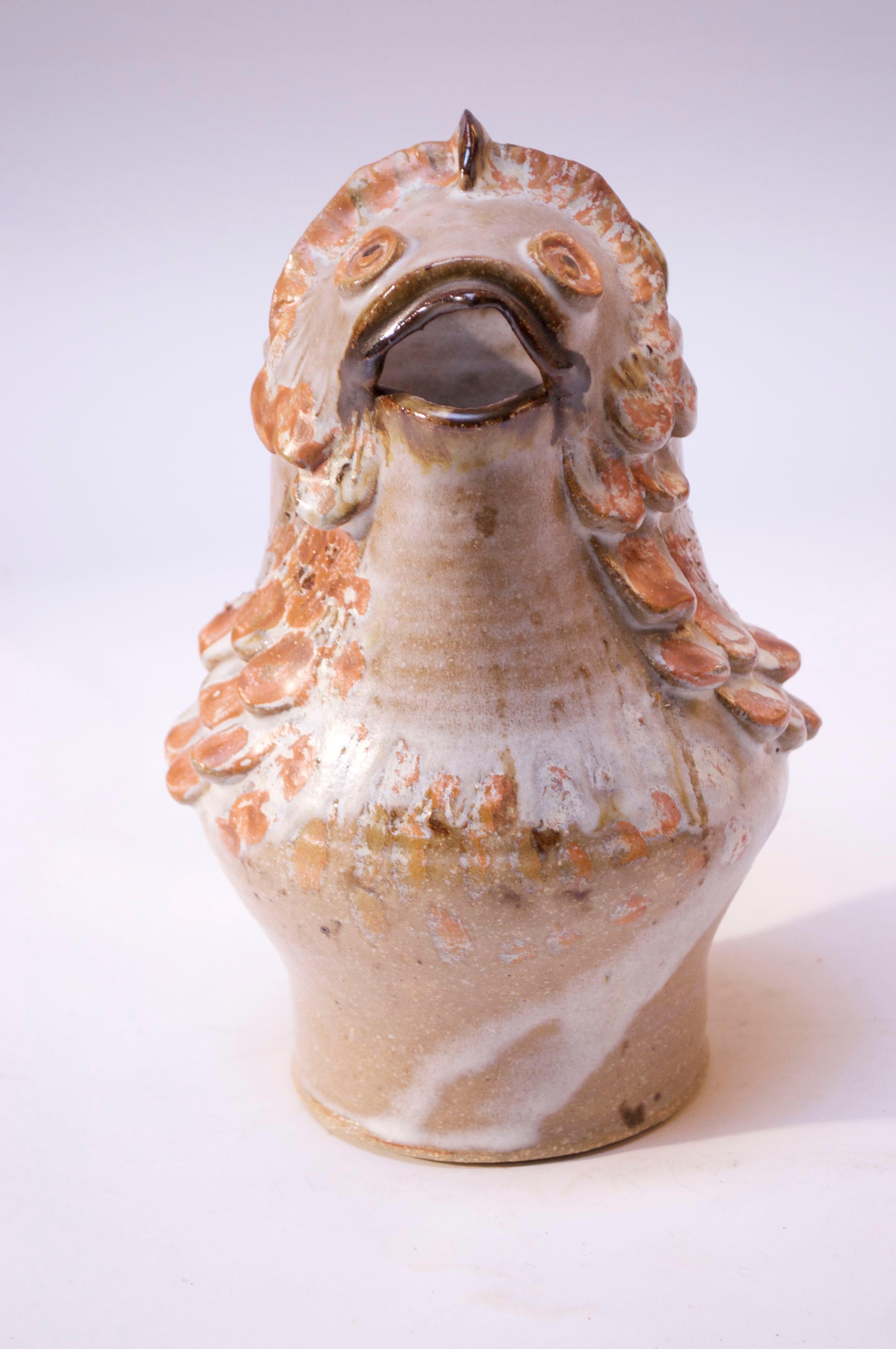 Art pottery fish pitcher in attractive palette of beige, peach, brown, tan, and white. Heavily textured scale decoration throughout, 'frosted' with a dense white glaze. Signed 'Rush 76' tot the underside.