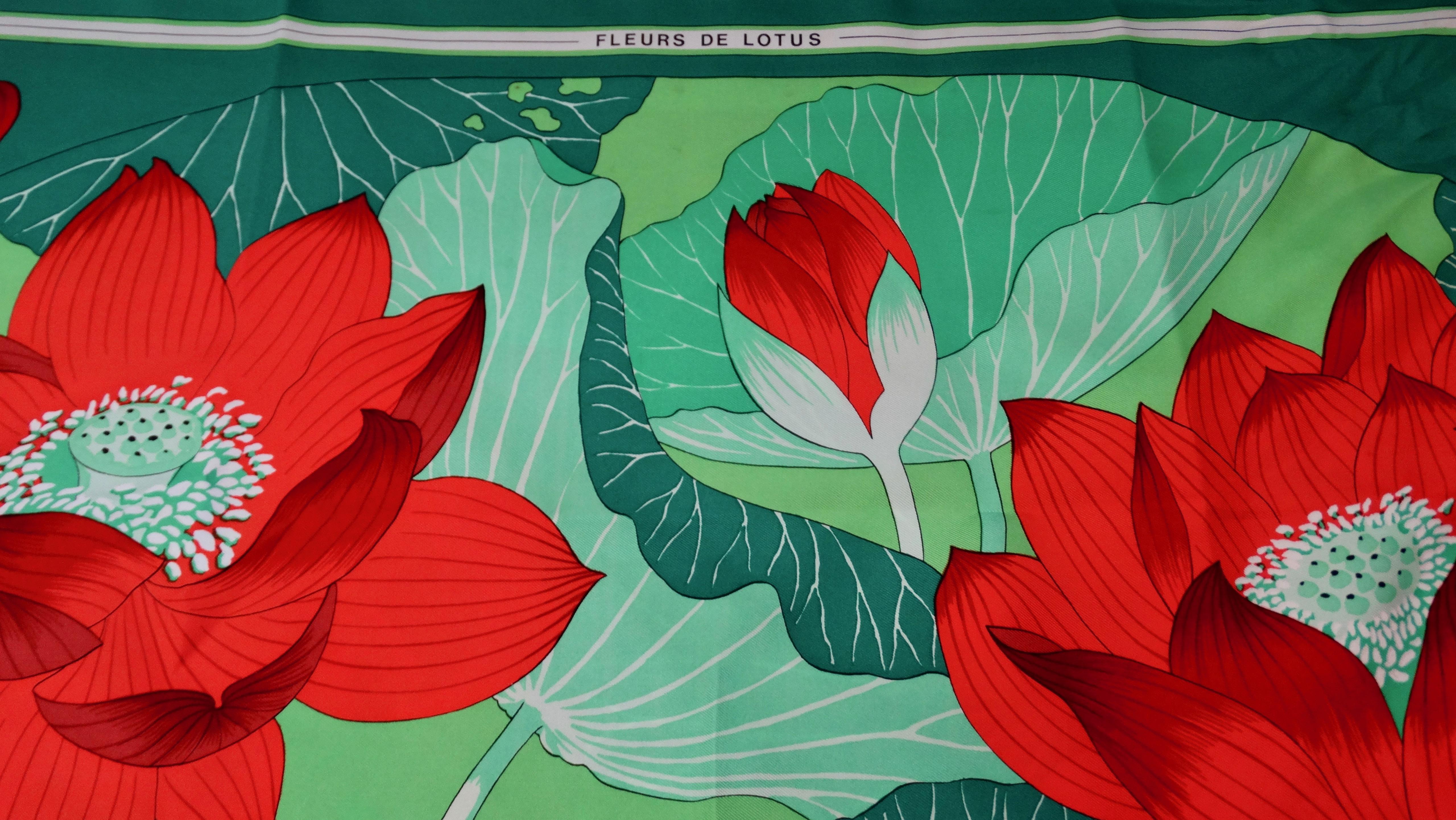 We all need a great Hermés scarf! Circa 1976, this 100% Silk scarf features a beautiful motif designed by Christiane Vauzelles titled, 'Fleurs De Lotus.' Includes large red lotus flowers surrounded by various contrasting shades of green vegetation.