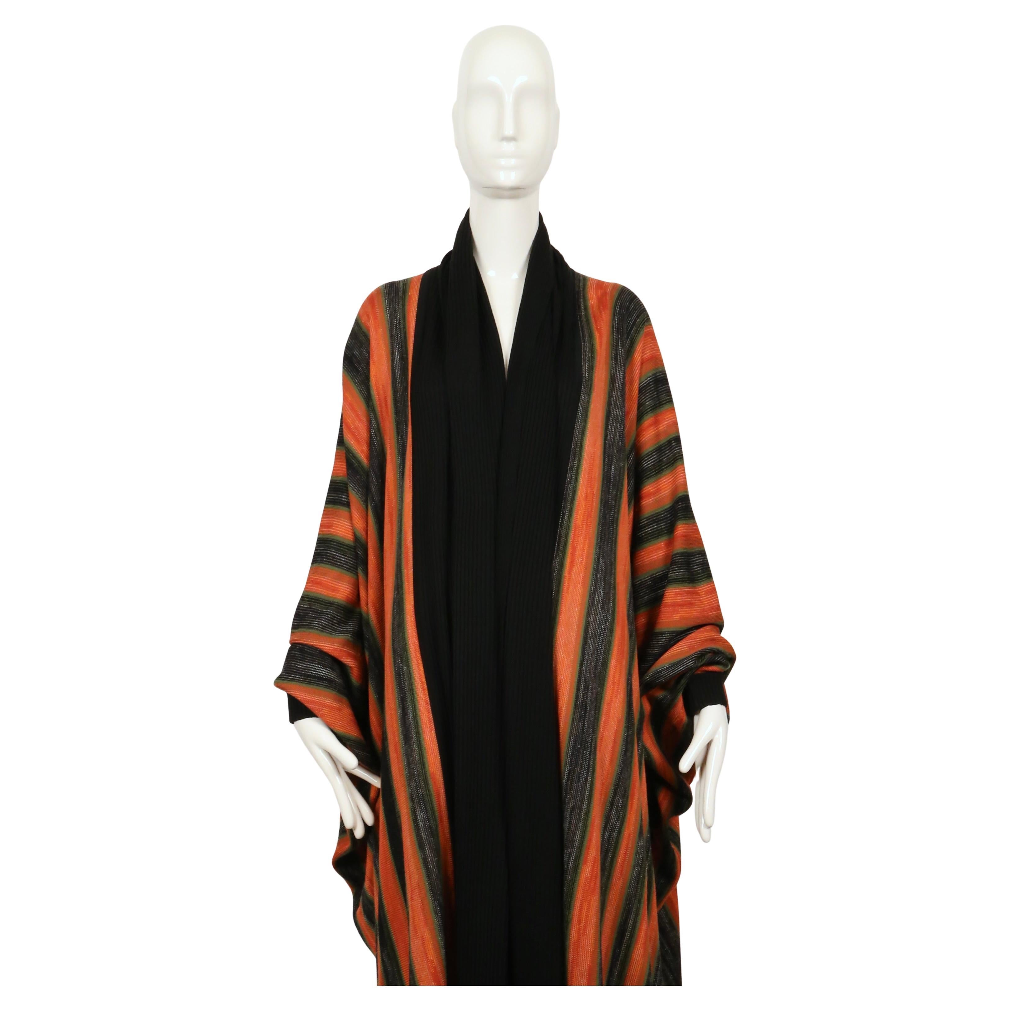 Extremely rare, space-dyed knit robe coat with shawl collar and ribbed trim designed by Issey Miyake dating to fall of 1976. Documented piece. Labeled a Japanese size 'M'. Fit is very oversized with a batwing sleeve and floor length. This coat will