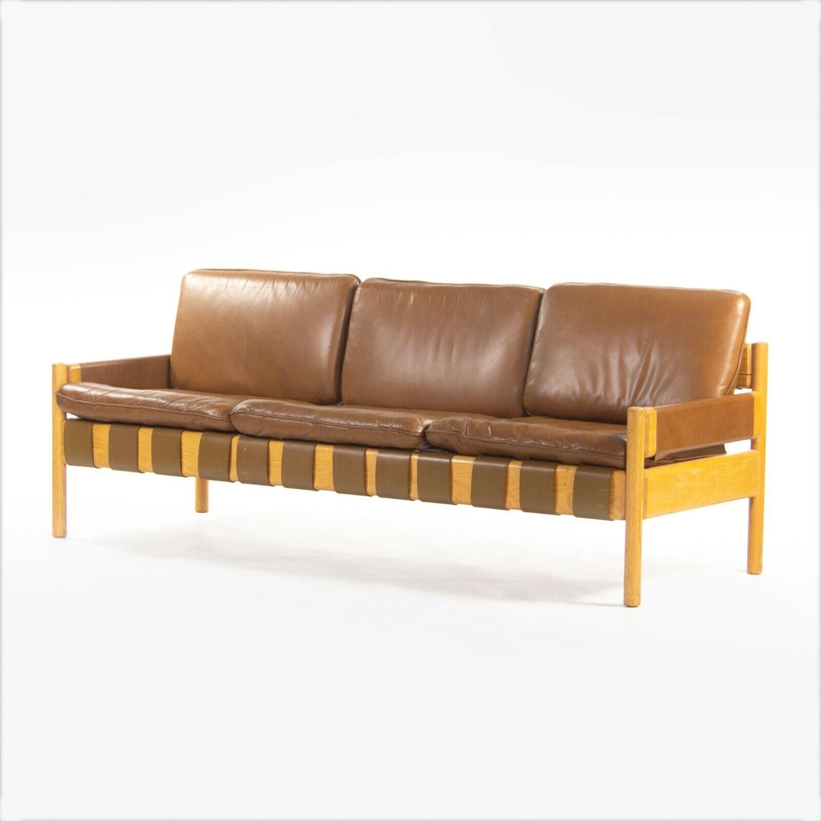Listed for sale is a leather and oak Nicos Zographos Saronis sofa from 1976, which came directly from a Hugh Stubbins (Architect) designed library at a notable ivy-league institution. Additional provenance will be disclosed at time of sale. This