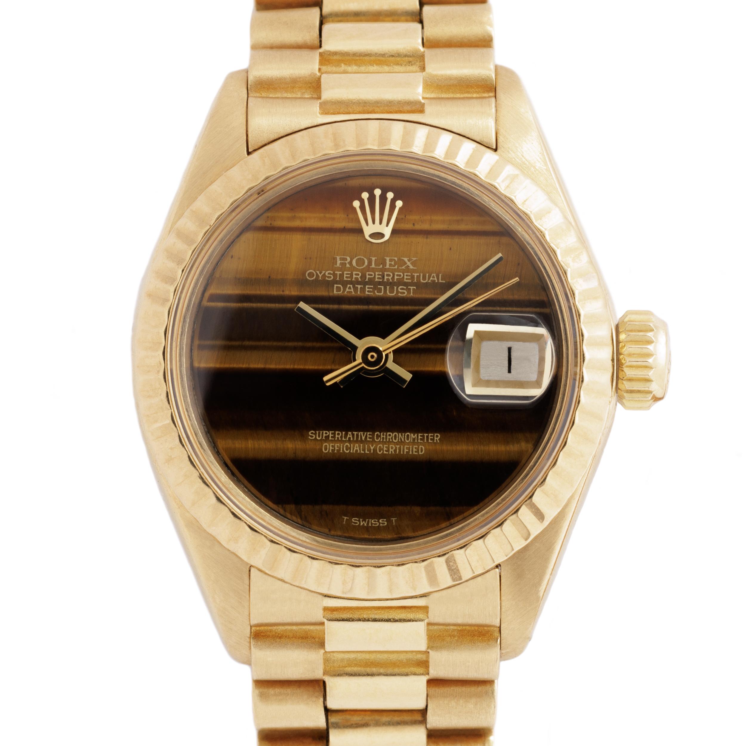 1976 Rolex 18 Karat Yellow Gold DateJust Model 69178

Vintage Rolex 18 Karat Yellow Gold Ladies DateJust with a RARE and original Rolex Tiger Eye's eye dial 
circa 1976
26mm Dial
Automatic movement

Currently fits up to a 7
