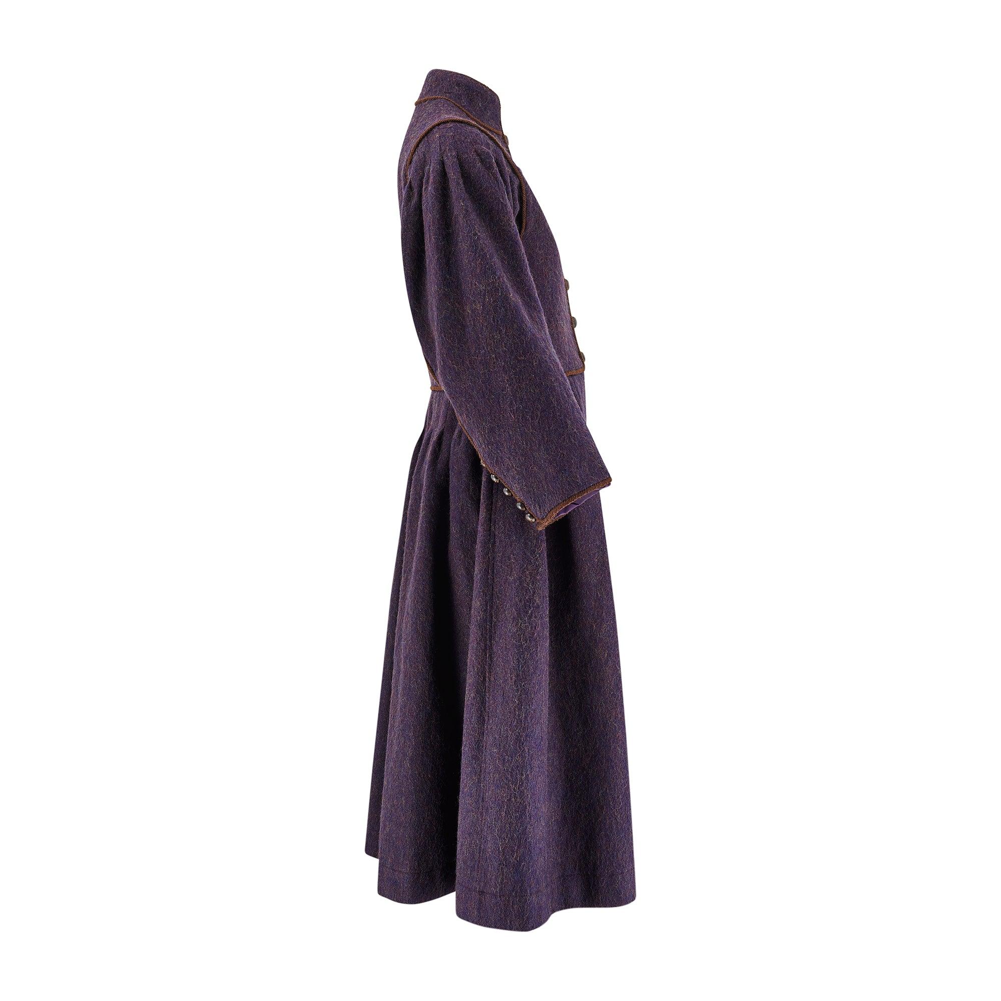 This runway documented aubergine-hued felt wool coat was created by Yves Saint Laurent for the brand’s beloved Fall 1976 collection. This collection was titled “Opéras - Ballets Russes”, a collection that the New York Times described as “A