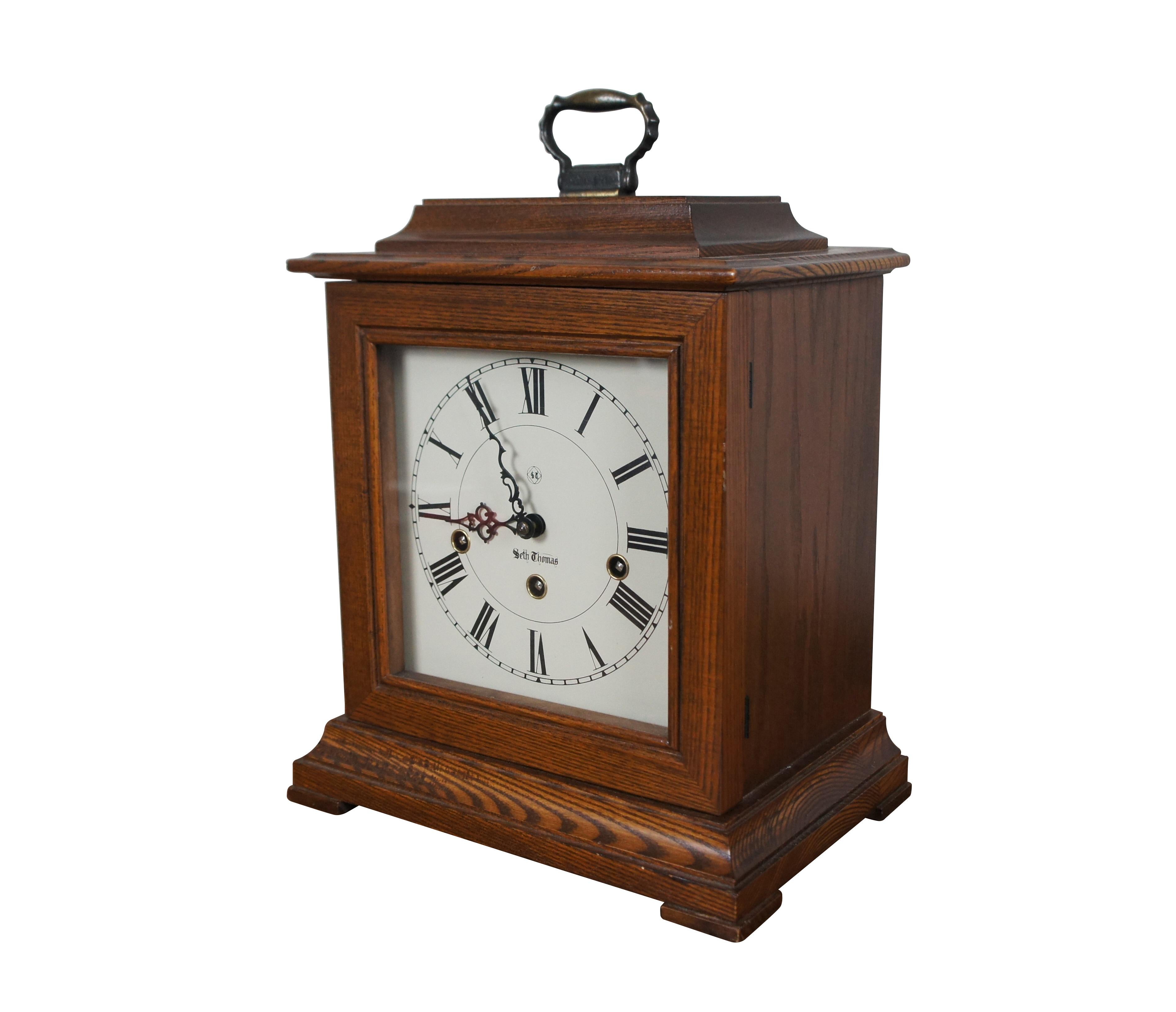 Vintage 1976 Seth Thomas Heirlooms of Tomorrow collection 8-day, key wound, mantel clock with Westminster chimes. Rectangular hardwood case with brass handle at the top. White face with black Roman numerals and scrollwork hands. Cat #: 1308 - Name: