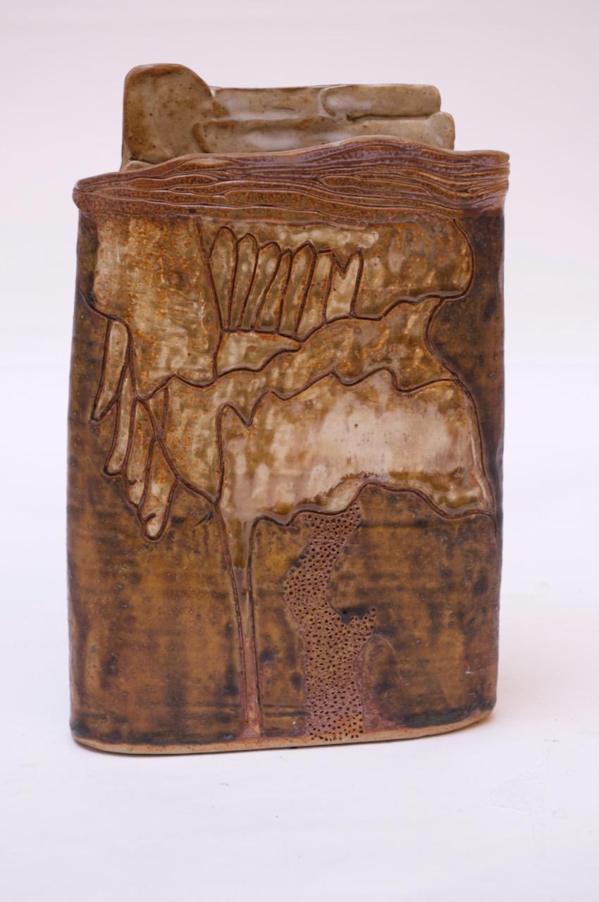 Vase en grès dans une palette de brun et de havane représentant un décor floral abstrait sur les deux côtés, réalisé en 1976 par le céramiste Pollack.
Signé 