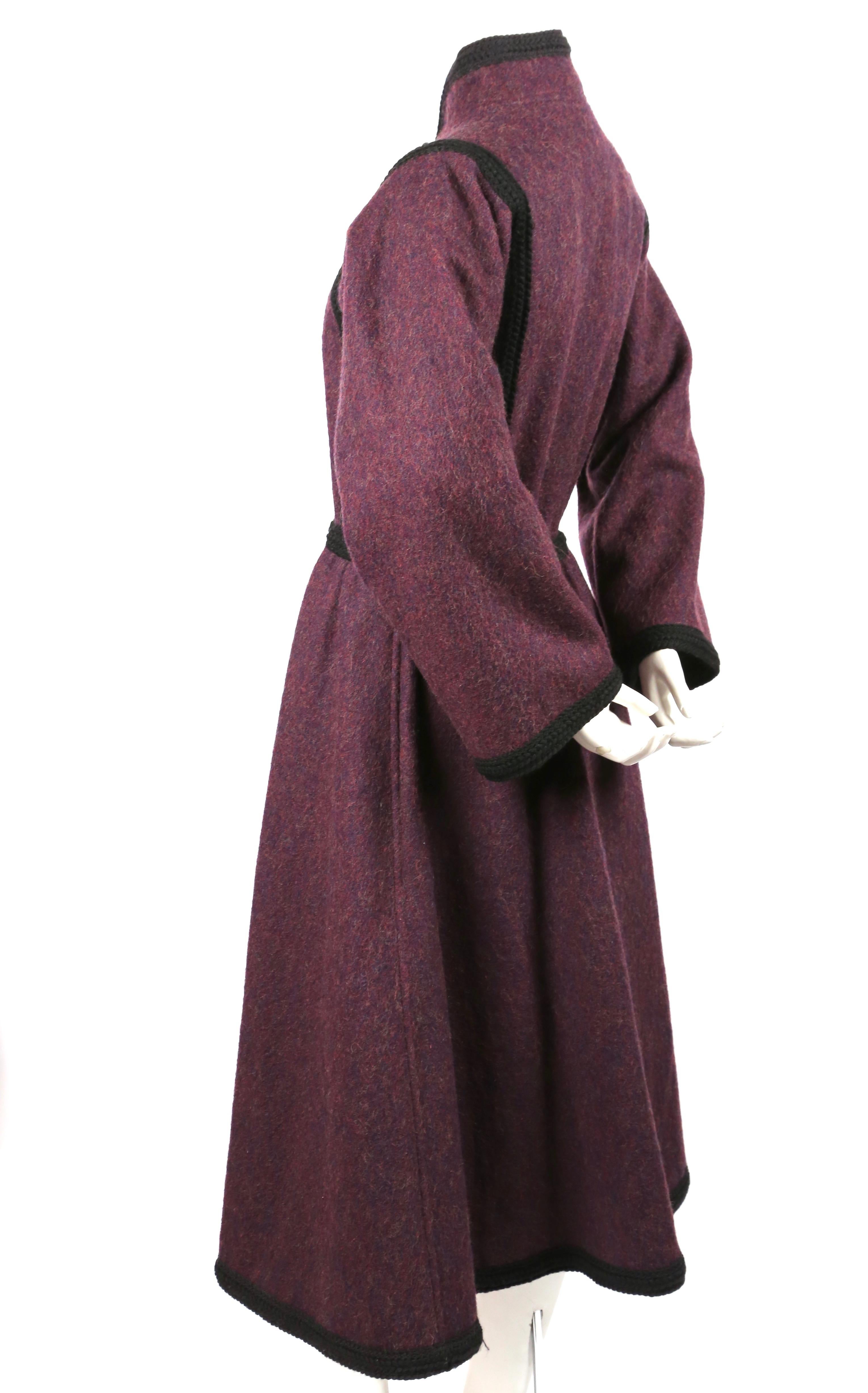 Very rare purple wool coat with fitted bodice, full sleeves, toggle closure and braided trim by Yves Saint Laurent dating to fall of 1976 from the well documented 'Russian Collection'. Labeled a French size 38. Approximate measurements: shoulder