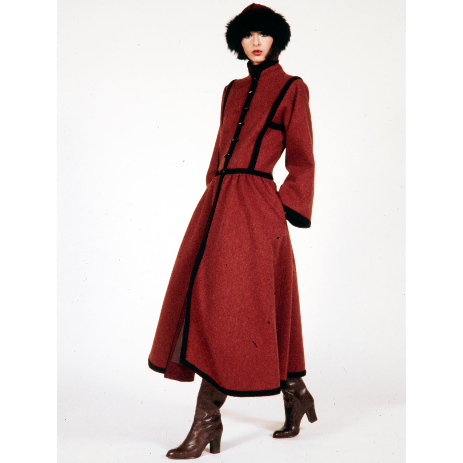 This 1976 YSL burgundy red wool Cossack style coat is an iconic piece from Yves Saint Laurent. This incredible coat was inspired by the Haute Couture Ballet Russes Collection and the quality and details are exceptional. Saint Laurent was inspired by