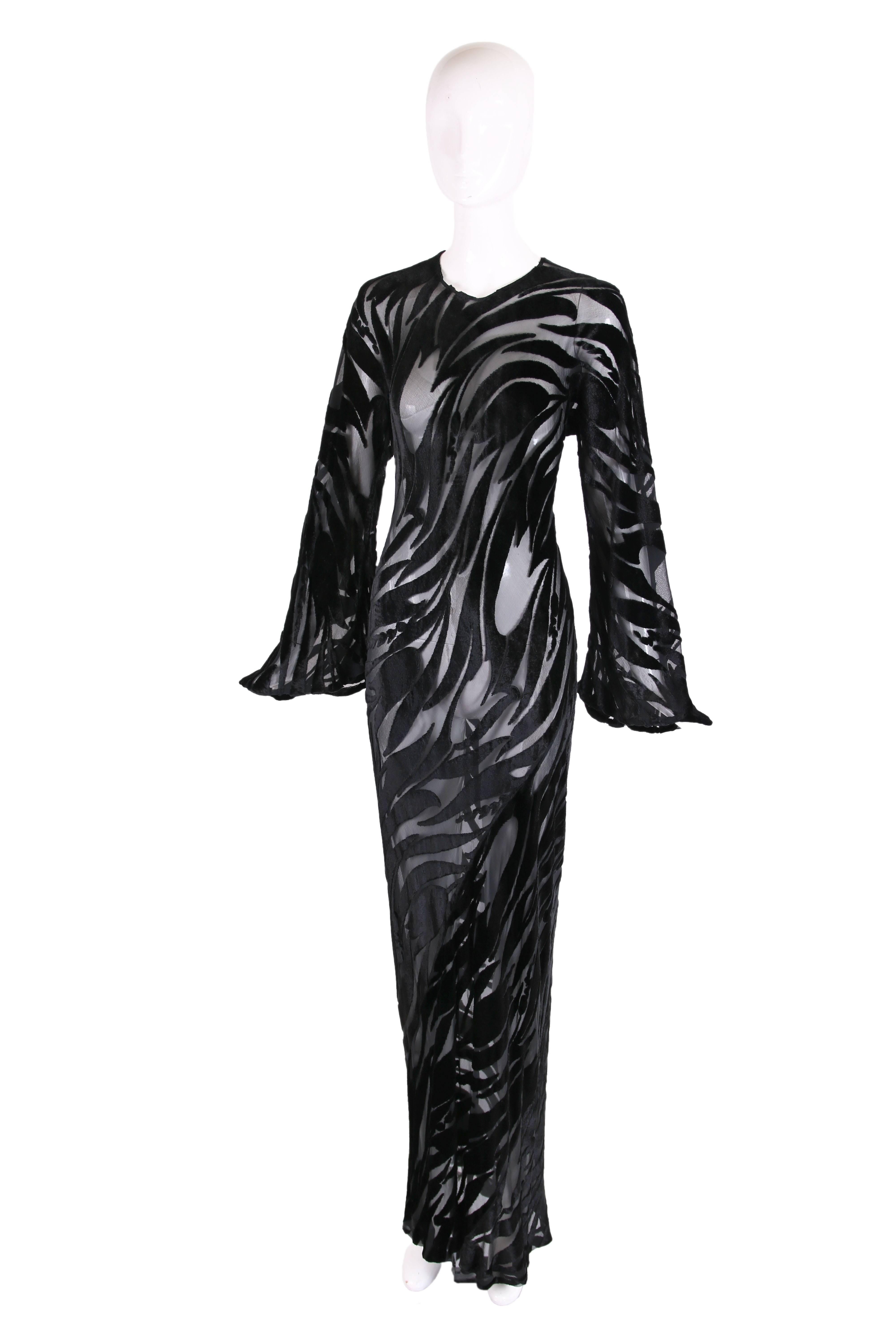 1974 Halston black silk velvet burnout bias cut evening gown w/tulip pattern and bell sleeves. At the back neck is a keyhole opening and hook closure. Gown is missing its label but it is without a doubt by Halston - see photo included in this