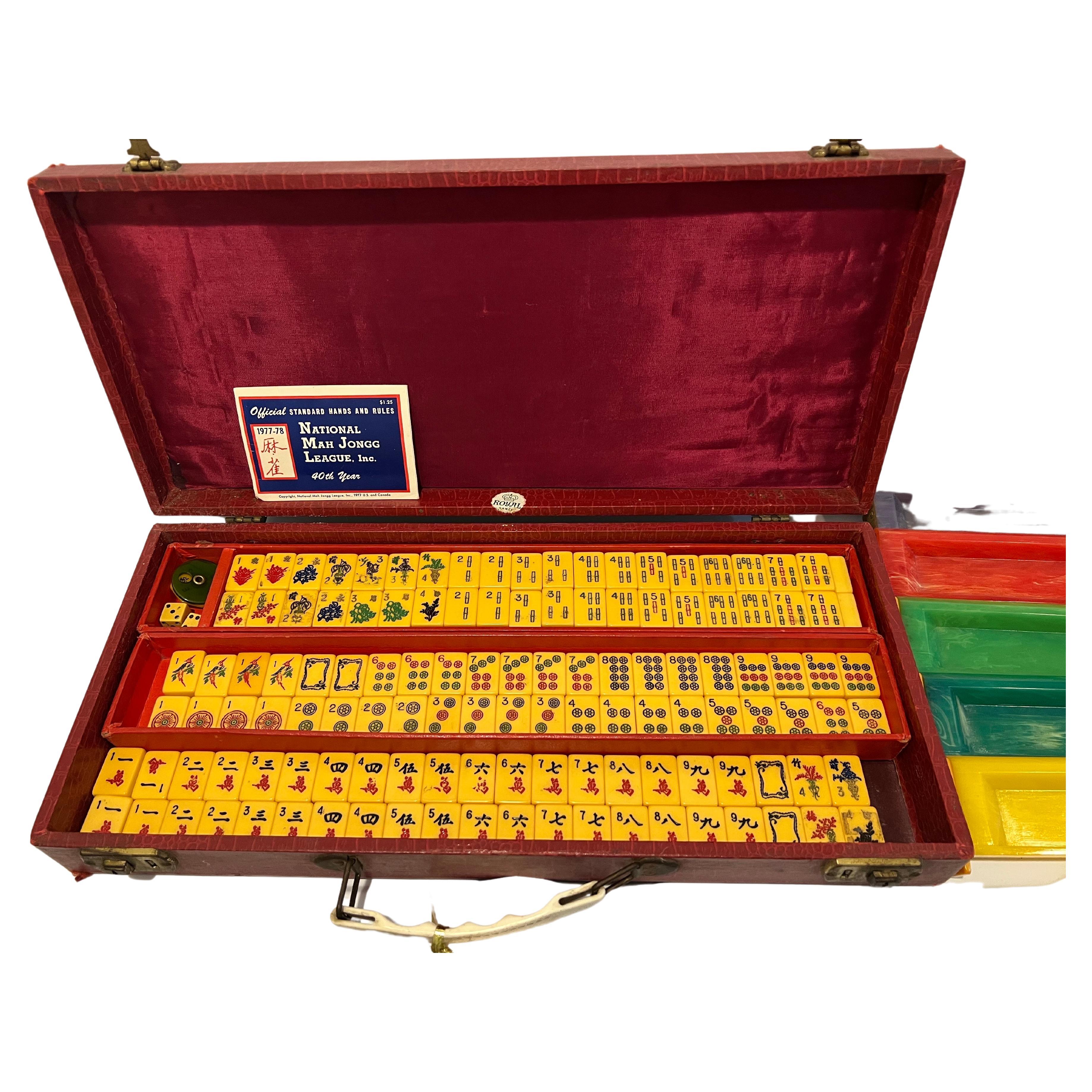 National Mahjong League Bakelite set with original case. Special 40th anniversary production. Dated 1977-1978.  Original carrying case is a faux alligator finish in red. The set comes with a vintage bakelite bettor, two dice , 5 bakelite trays and