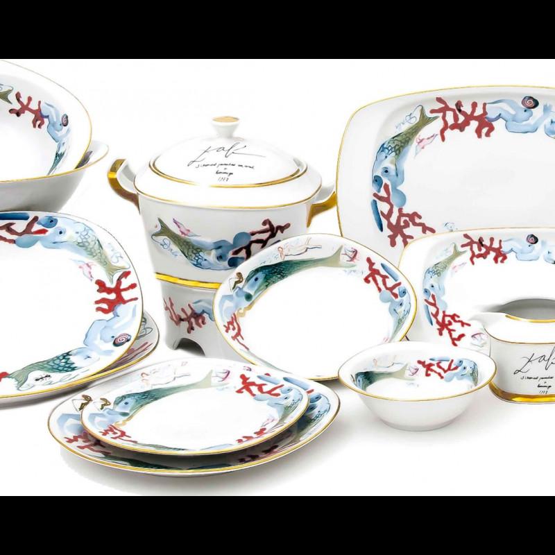 Salvador Dalí (1904-1989) world-famous Spanish painter, graphic artist, and sculptor of surrealism designed this ceramic edition painted porcelain with 24-karat gold trim, complete dinner service for 12. 
Limited edition, plates are signed, on front
