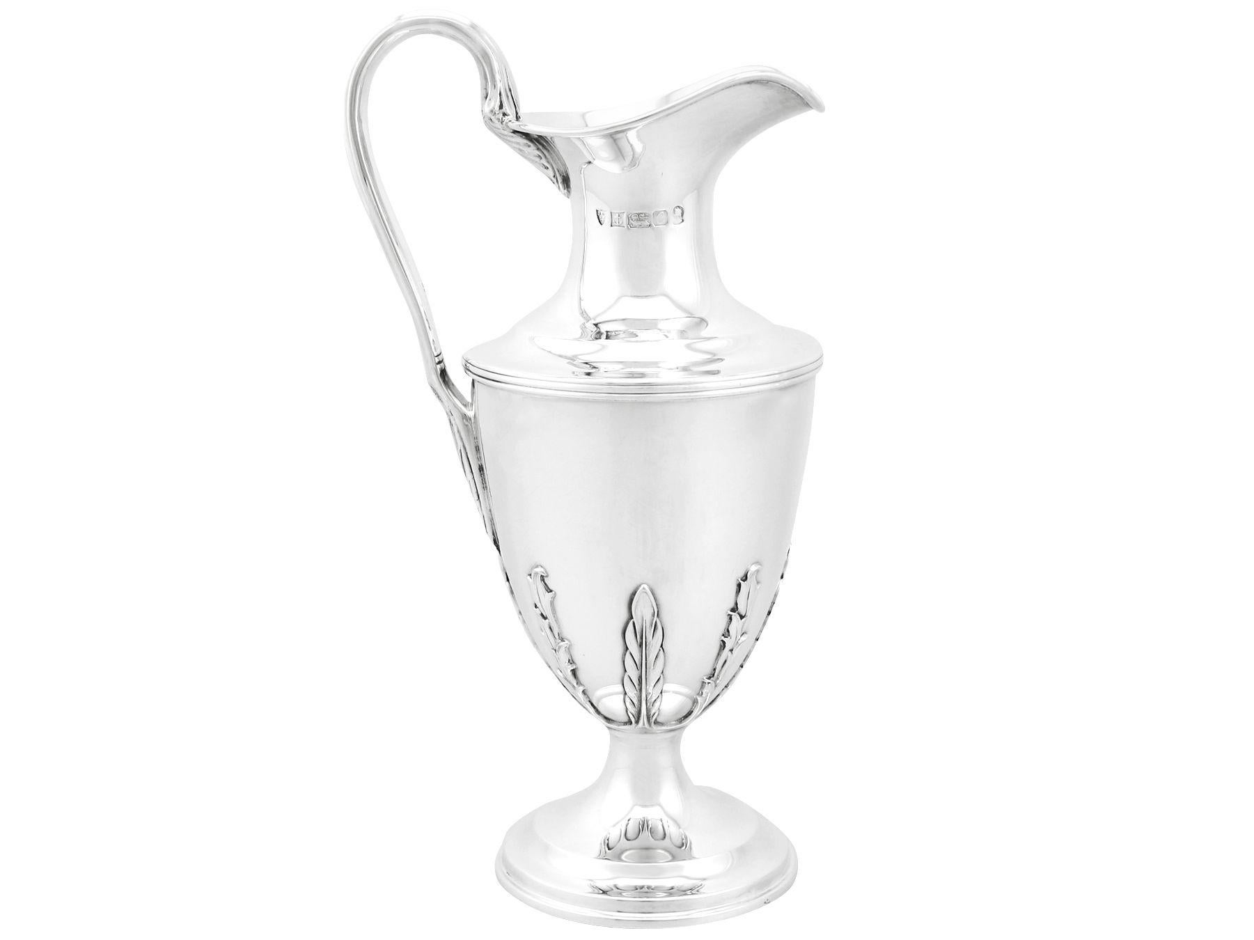 An exceptional, fine and impressive vintage Elizabeth II English sterling silver claret jug with matching goblets; an addition to our range of drinks related silverware.

This exceptional Victorian sterling silver set consists of a claret jug and