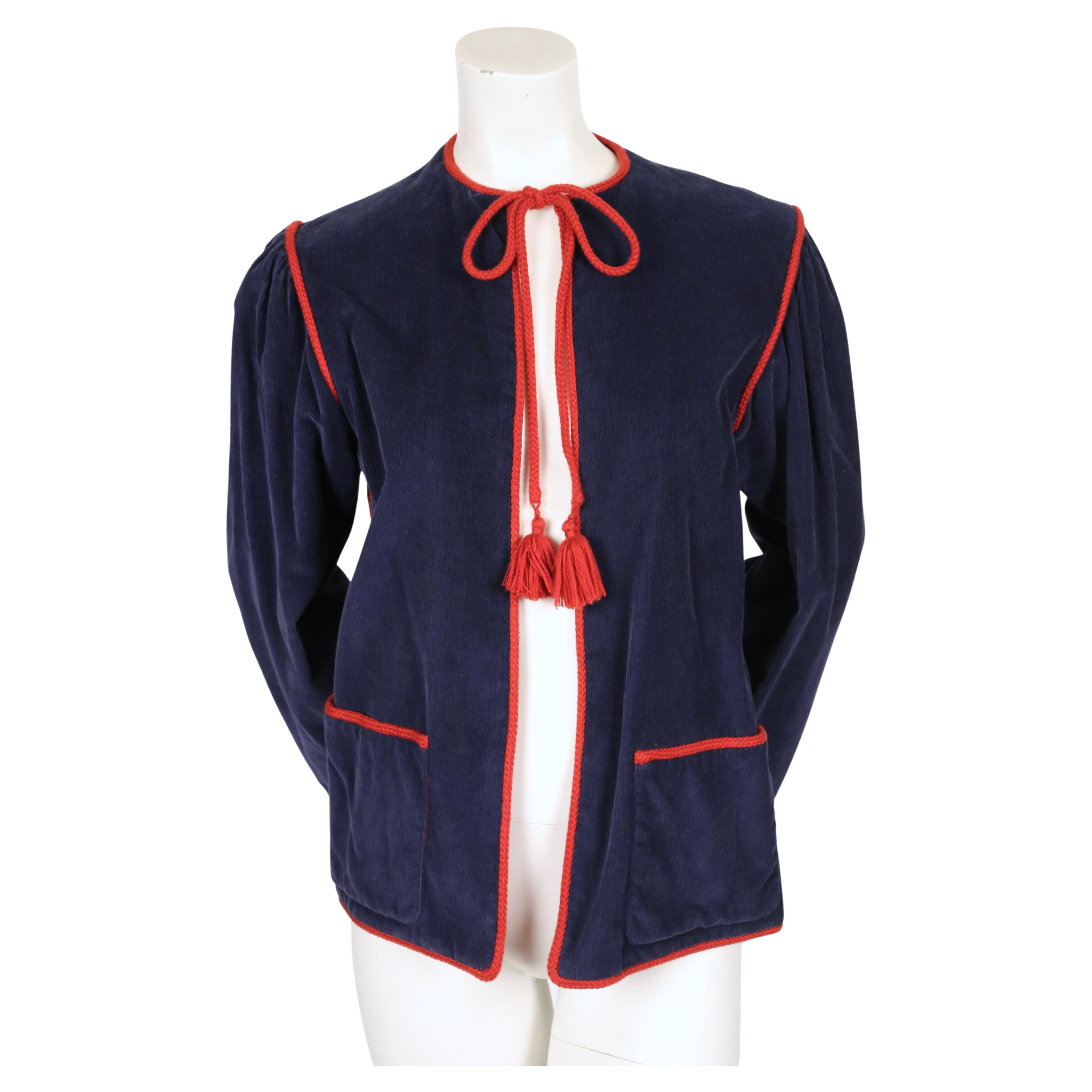 Blue, corduroy peasant jacket with deep red rope trim, tie closure and tassels designed by Yves Saint Laurent as seen on the spring 1977 runway. French size 40 however it best fits a size 2-6. Jacket was not clipped. Approximate measurements: