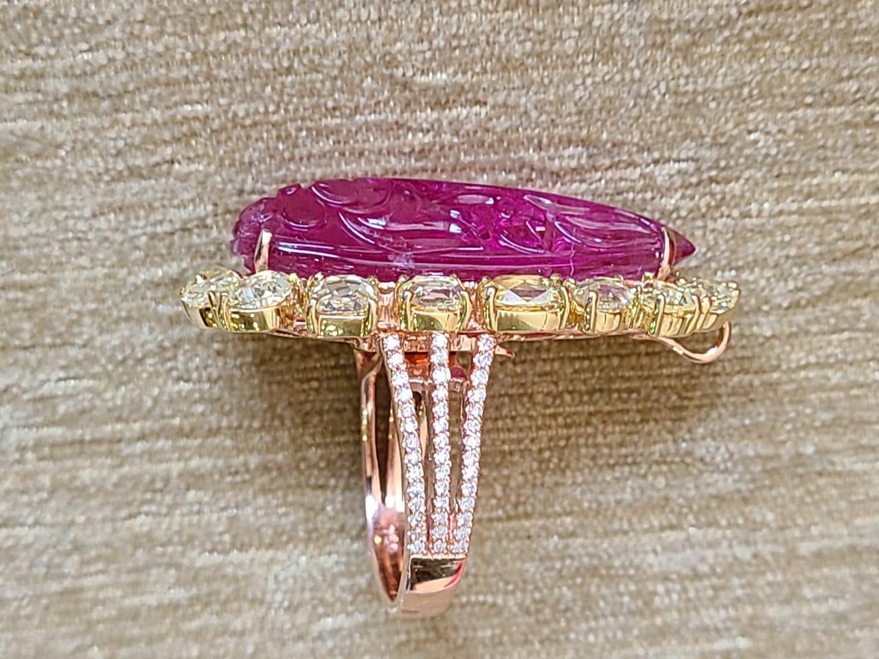 A very beautiful & one of a kind, carved Rubellite Cocktail Ring/ Convertible Pendant set in 18K Gold & Diamonds. The weight of the Rubellite is 19.78 carats. The Rubellite is hand carved in our own workshop. The combined weight of the Diamonds is