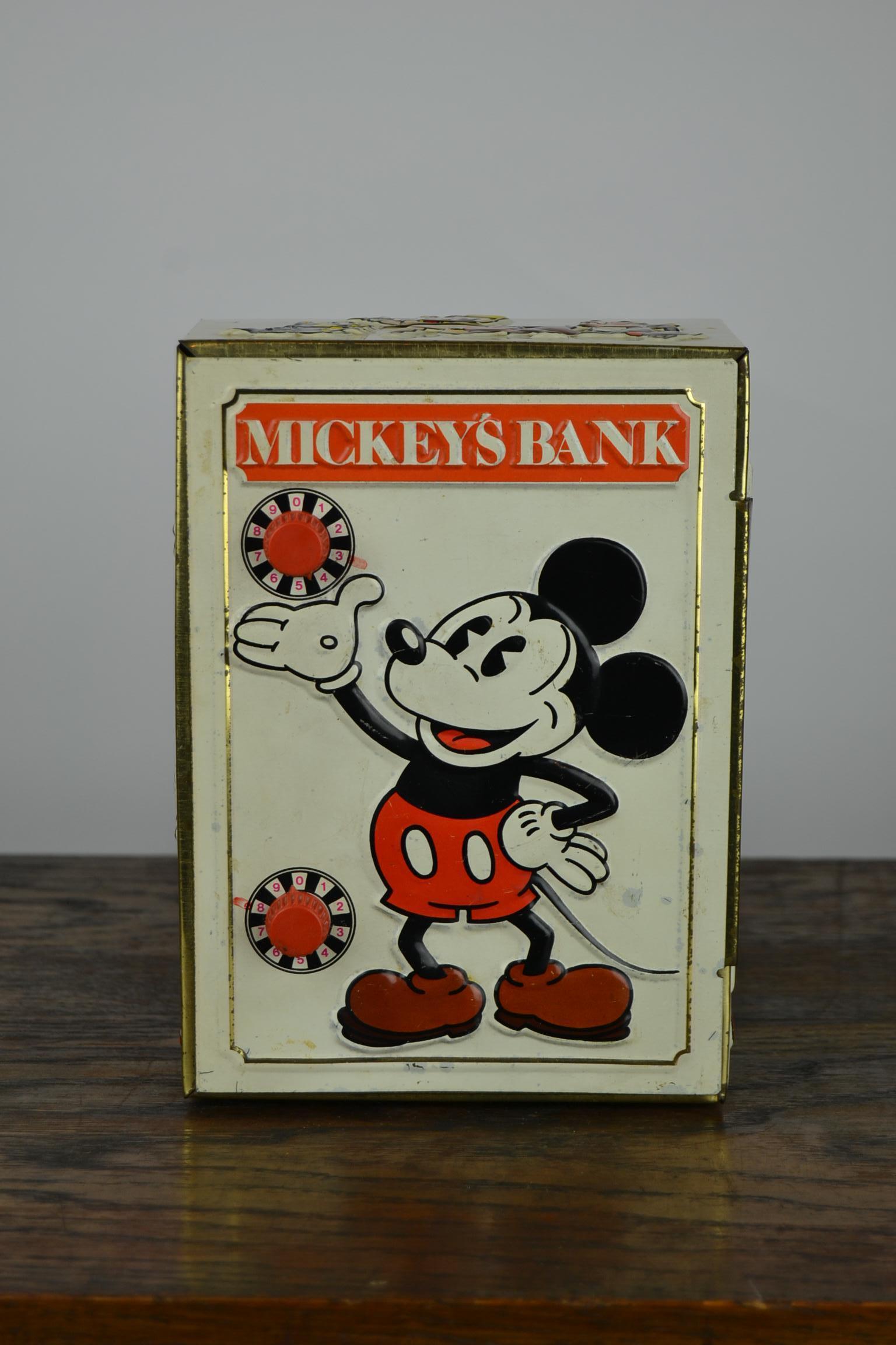 Vintage toy coin bank - Bank Safe with the famous Walt Disney Animation Characters:
Mickey Mouse, Goofy, Pluto, Piglet, Minney Mouse, Donald Duck.
All this comic figures are embossed on the tin bank.
The miniature safe has 2 working combination