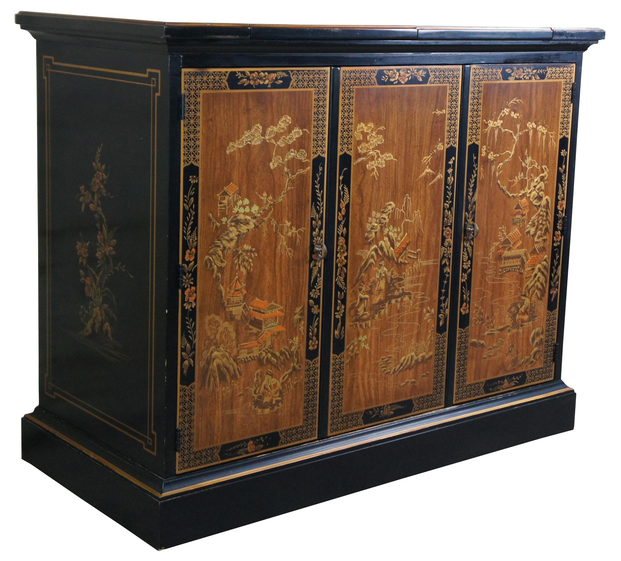 Drexel Et Cetera Chinoiserie buffet, cabinet, server or dry bar, circa 1978. A rectangular form with black lacquer and natural wood front finished in beautiful pagoda and geisha landscapes. The cabinet is trimmed in gold with floral and fruit