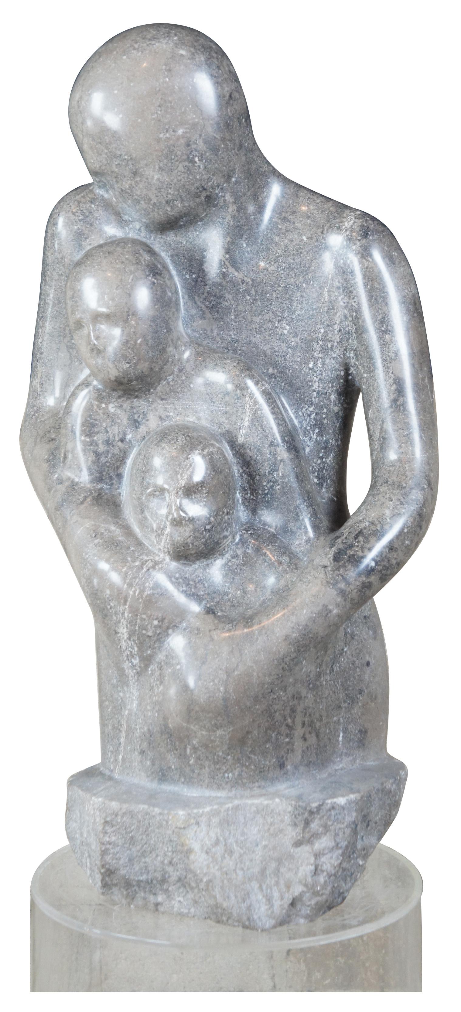 G Turner 1978 marble sculpture with Lucite base. Features a woman holding onto her children. Singed along the edge of base.

Measures: Sculpture 30